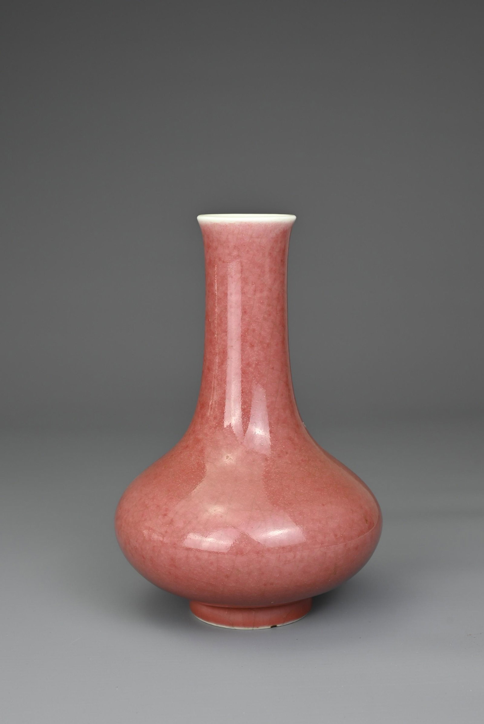 A CHINESE PEACHBLOOM GLAZED PORCELAIN BOTTLE VASE, QIANLONG MARK. Compressed pear shaped body with (1 of 7)