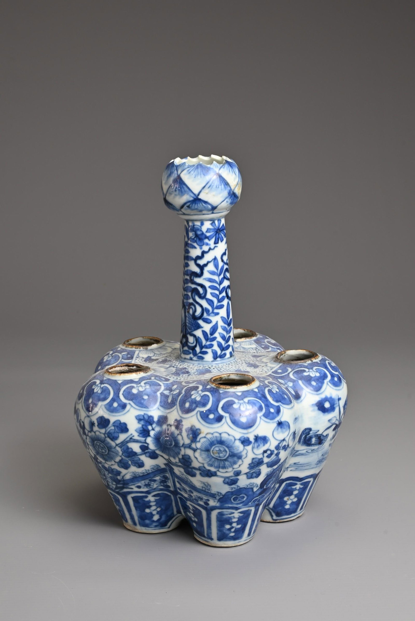 A CHINESE BLUE AND WHITE PORCELAIN TULIP VASE, MID 19TH CENTURY. With five compartments around the: A CHINESE BLUE AND WHITE PORCELAIN TULIP VASE, MID 19TH CENTURY. With five compartments around the body with a tapering cylindrical neck leading to a lotus bud mouth. Decorated with ducks in a pond su