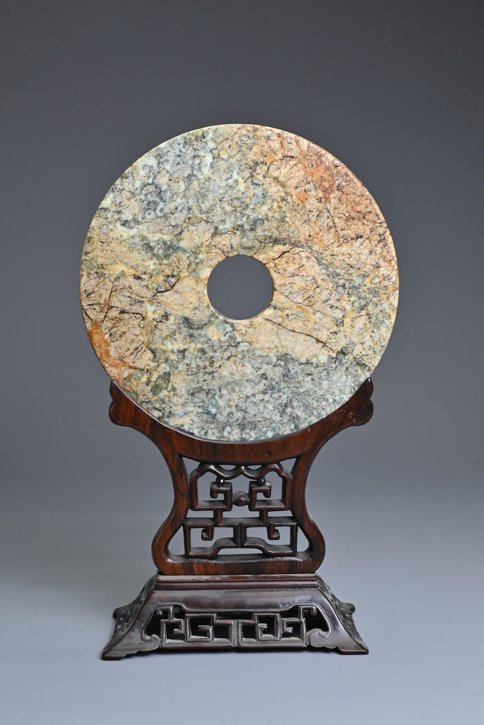 A LARGE CHINESE JADE BI DISC ON WOODEN STAND. The circular jade disc with incised decoration to one (1 of 6)
