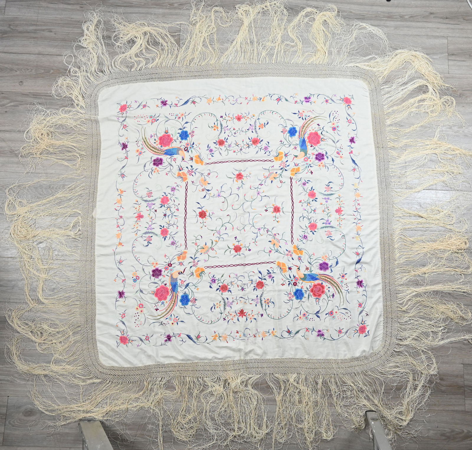 AN EARLY 20TH CENTURY CHINESE EMBROIDERED CREAM SILK SHAWL. Embroidered with exotic pheasants, (1 of 8)