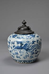 A CHINESE BLUE AND WHITE PORCELAIN PHOENIX JAR, LATE MING DYNASTY. Decorated with two phoenix in: A CHINESE BLUE AND WHITE PORCELAIN PHOENIX JAR, LATE MING DYNASTY. Decorated with two phoenix in flight amidst floral scrolls. Four-character mark to base reading 'Yong bao chang chun', translated as