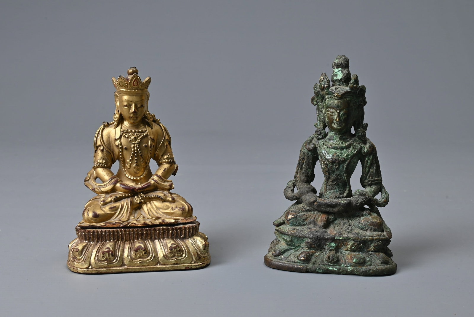TWO CHINESE FIGURES OF BUDDHA, PROBABLY 19TH CENTURY. Each seated on a lotus base in bronze with (1 of 8)