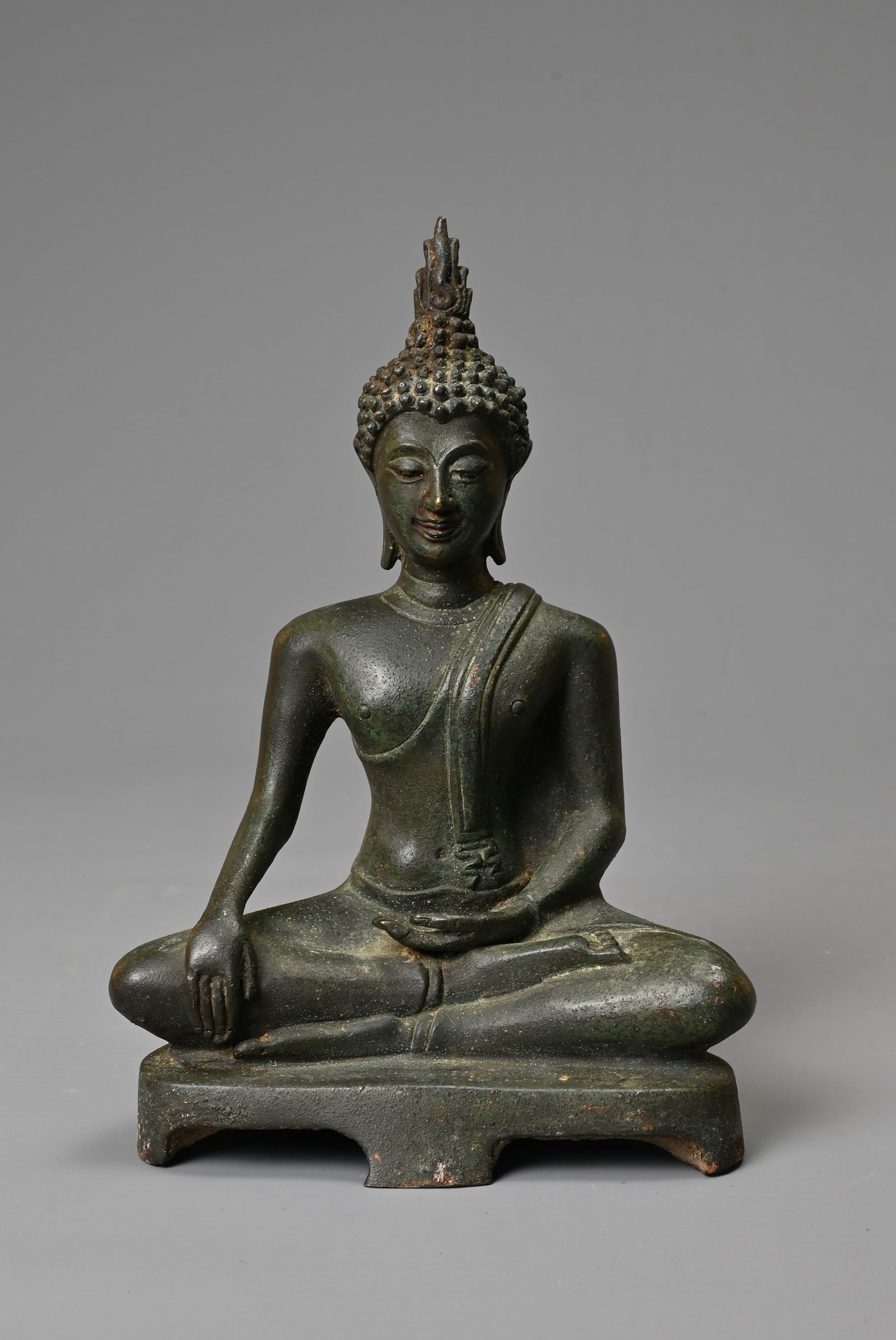A THAI BRONZE FIGURE OF BUDDHA, 20TH CENTURY. Dressed in robes in Bhumiparsha mudra pose. 19cm tall.: A THAI BRONZE FIGURE OF BUDDHA, 20TH CENTURY. Dressed in robes in Bhumiparsha mudra pose. 19cm tall. No signs of damage or repair. Surface wear only to note.