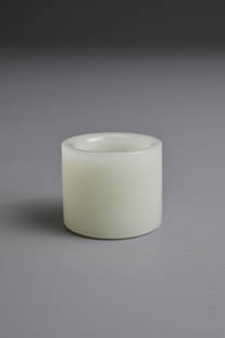 A CHINESE WHITE JADE ARCHER'S RING, QING DYNASTY. Of cylindrical form, with one rounded edge and one: A CHINESE WHITE JADE ARCHER'S RING, QING DYNASTY. Of cylindrical form, with one rounded edge and one canted edge. 2.7cm length. 3.2cm outer diameter. Weight 28 grams. Good overall condition with no da