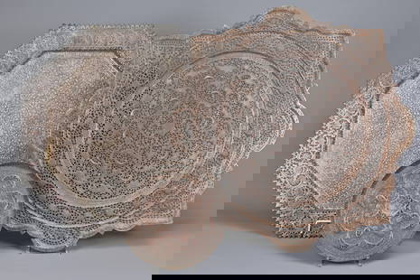 TWO COPPER INDO-PERSIAN TRAY-TABLE TOPS AND A SMALL DISH SIMILAR, EARLY 20TH CENTURY. The first: TWO COPPER INDO-PERSIAN TRAY-TABLE TOPS AND A SMALL DISH SIMILAR, EARLY 20TH CENTURY. The first tinned/silvered and of octagonal section, pierced with shaped flowerheads to the border the centre dense