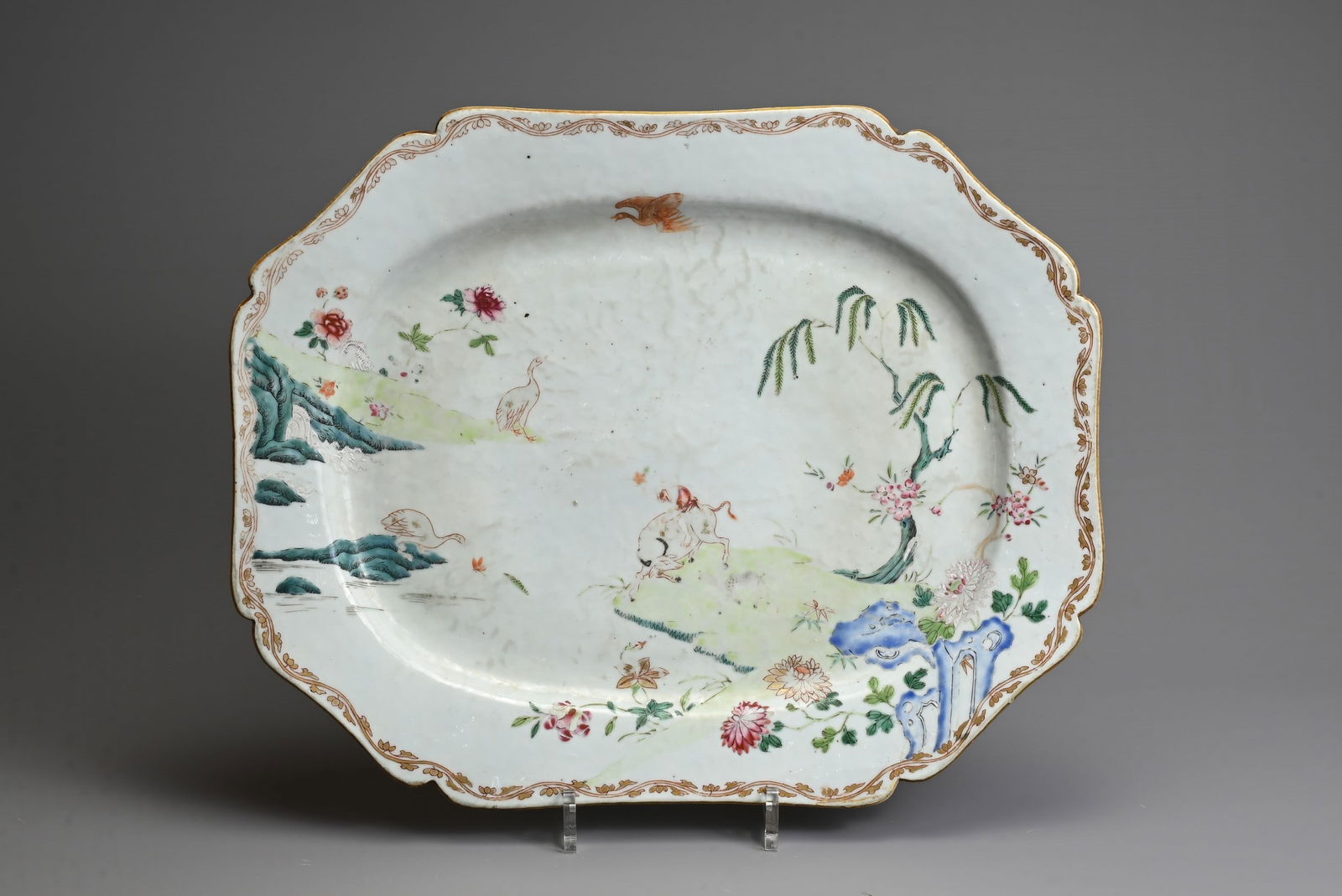 A LARGE CHINESE FAMILLE ROSE OCTAGONAL LOBED PLATTER, 18TH CENTURY. Decorated with boy seated on a (1 of 6)