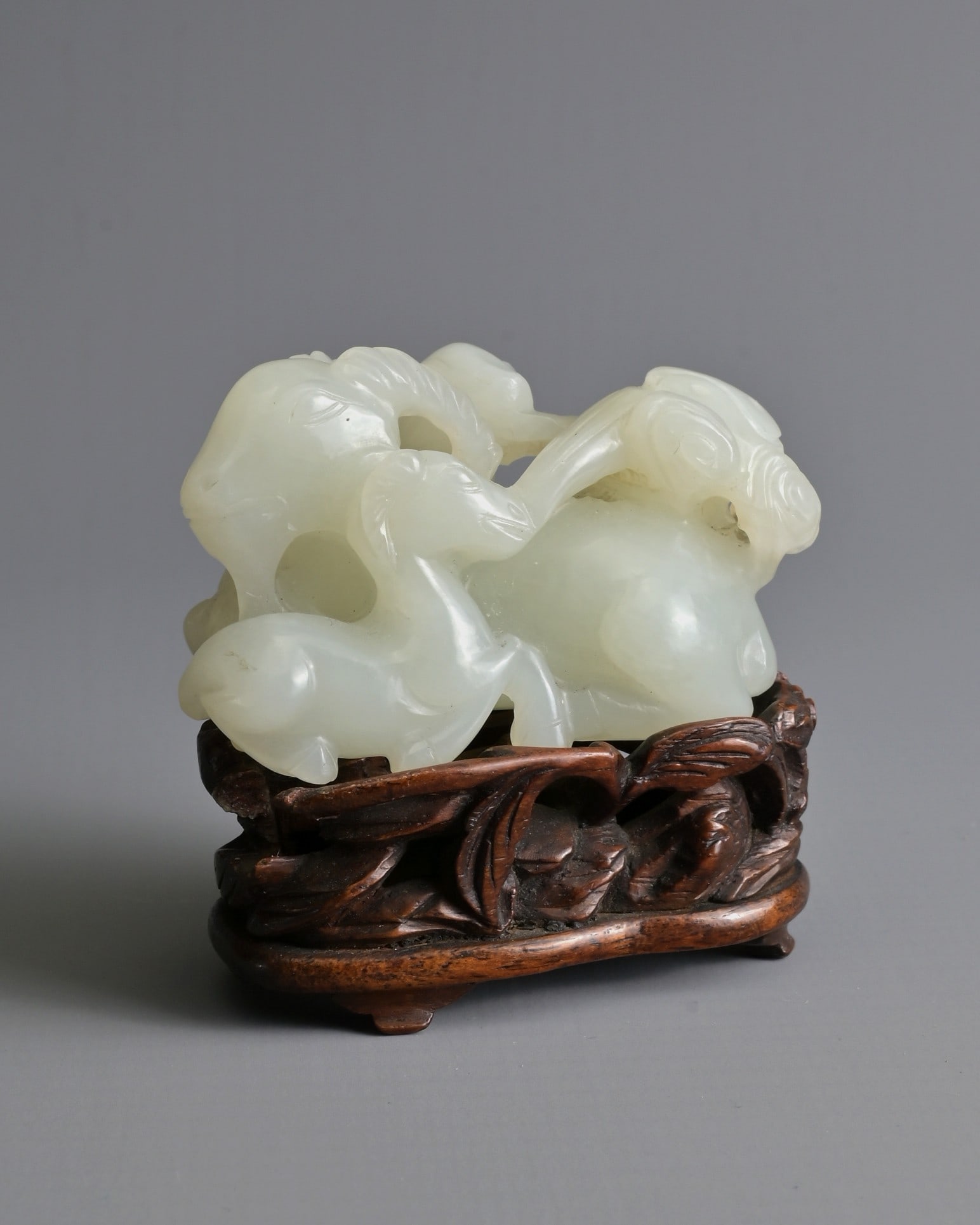 A CHINESE WHITE JADE DEER GROUP ON WOODEN STAND, 19/20TH CENTURY. Carved and pierced in the form (1 of 8)