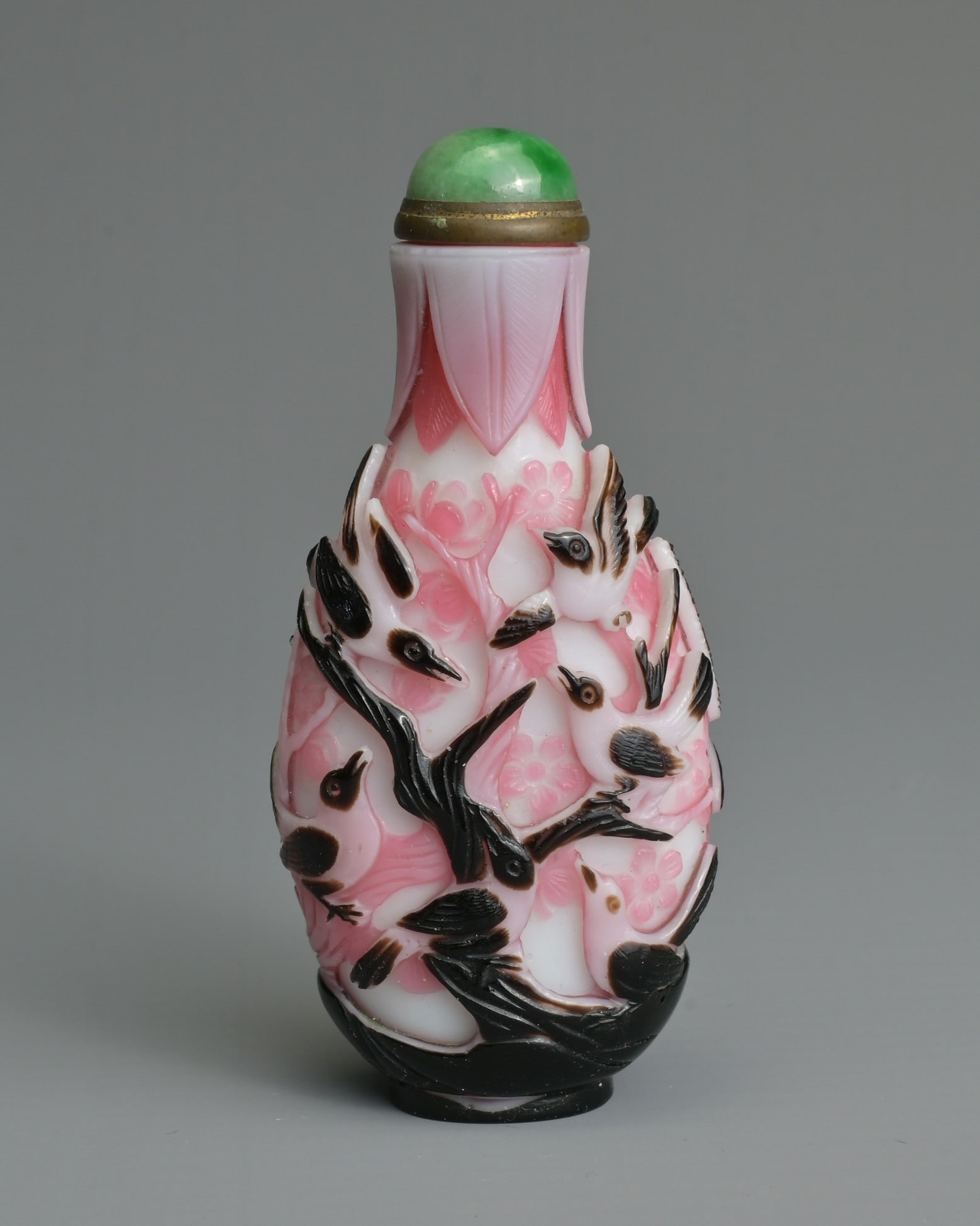 A CHINESE BLACK OVERLAY PINK AND WHITE SNUFF BOTTLE, QING DYNASTY. Of flattened ovoid form, well (1 of 9)