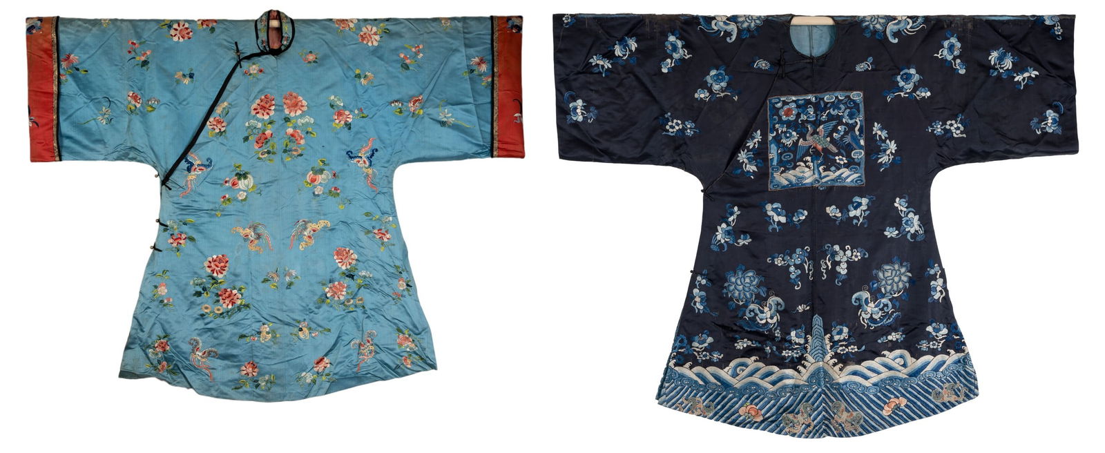 TWO CHINESE EMBROIDERED BLUE-GROUND SILK ROBES, CIRCA 1900 AND LATER. The first, earlier example, of (1 of 9)