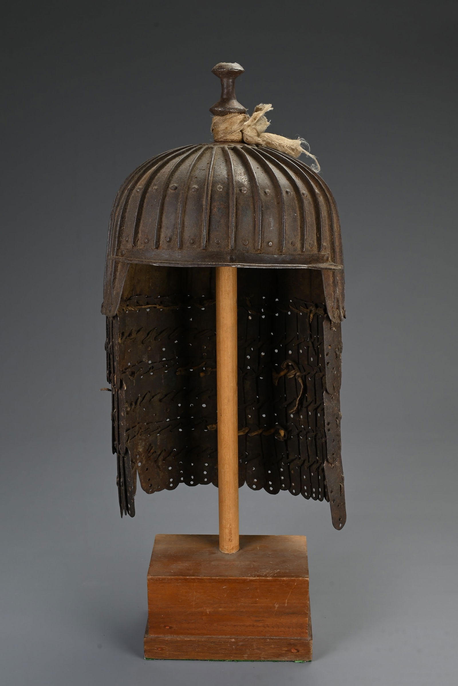 A TIBETAN METAL WARE PLATED HELMET, POSSIBLY 19TH CENTURY. Iron helmet made up of 29 plates held (1 of 4)