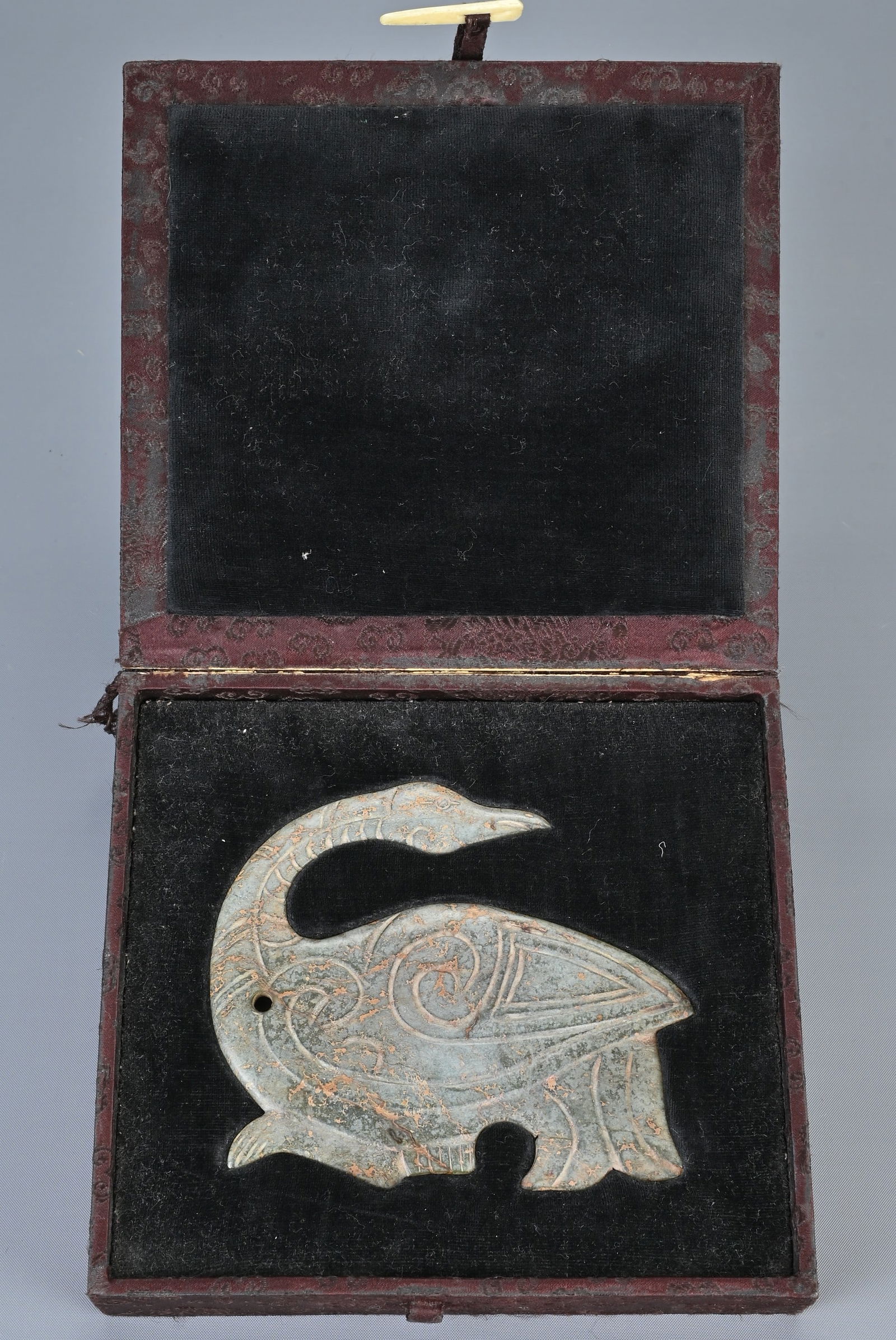 A LARGE CHINESE NEPHRITE JADE PENDANT IN THE FORM OF A PHOENIX. Recumbent figure with its head (1 of 3)