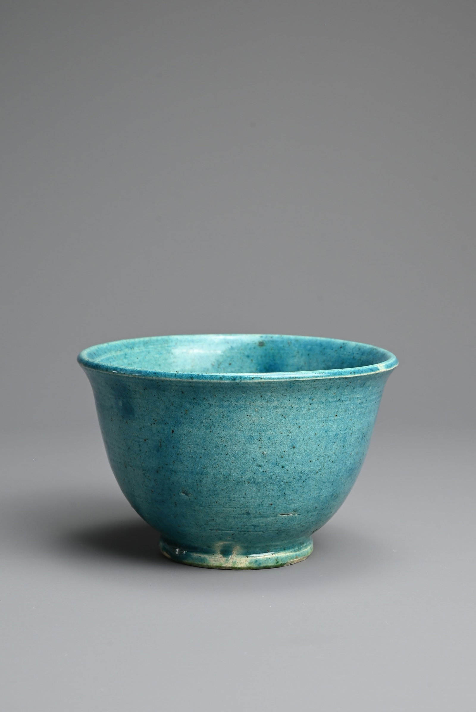A CHINESE TURQUOISE GLAZED PORCELAIN BOWL, LATE MING DYNASTY. Rounded body with slightly everted rim: A CHINESE TURQUOISE GLAZED PORCELAIN BOWL, LATE MING DYNASTY. Rounded body with slightly everted rim and splayed foot, covered in a thin turquoise glaze. 11.3cm diam. Provenance: Property of a Sussex 