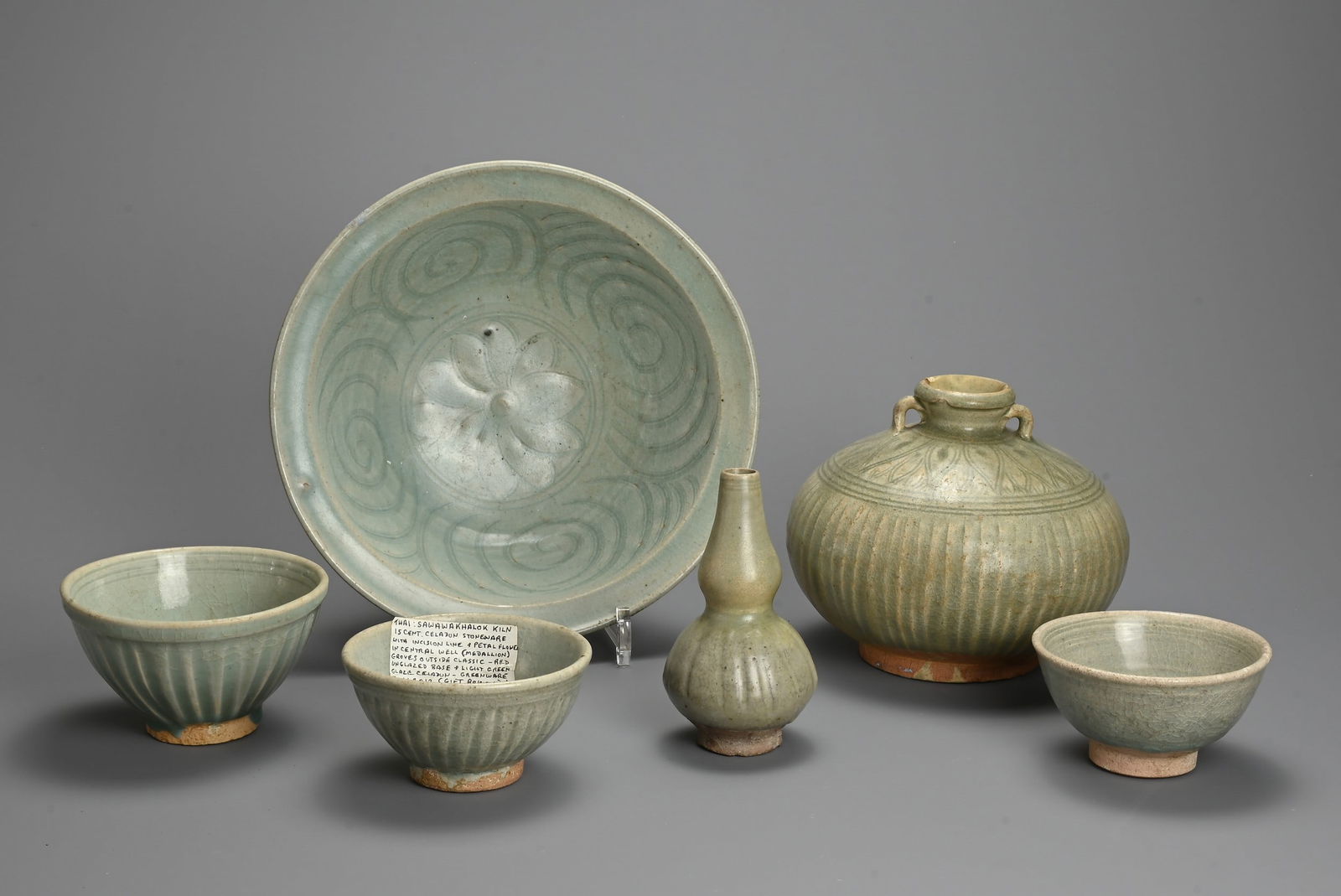 A GROUP OF THAI SAWANKHALOK CELADON GLAZED STONEWARE ITEMS, CIRCA 15TH CENTURY. To include a large (1 of 5)