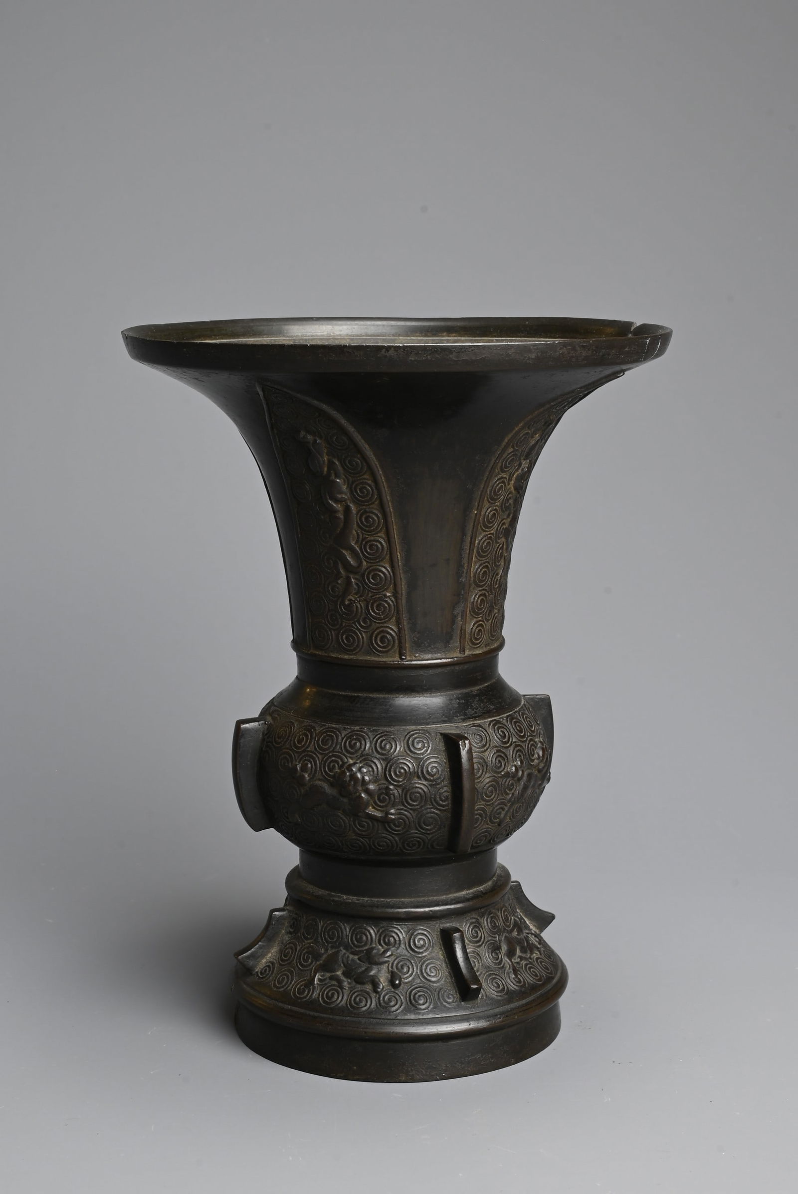 A CHINESE BRONZE GU VASE, QING DYNASTY. With wide flared mouth decorated to the foot and mid section (1 of 6)