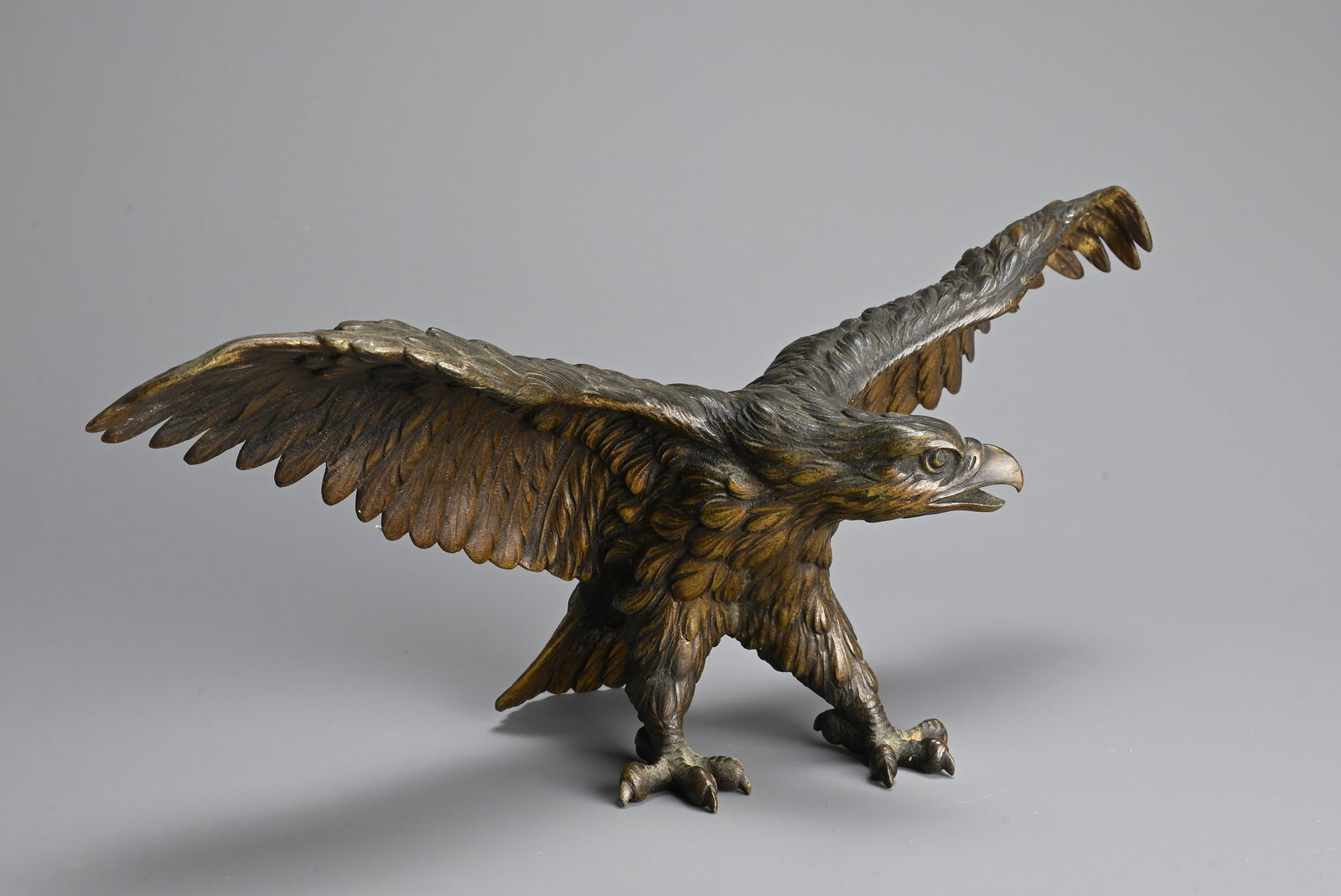A JAPANESE CAST BRONZE MODEL OF AN EAGLE, 19/20TH CENTURY. Well cast, standing with its wings (1 of 5)