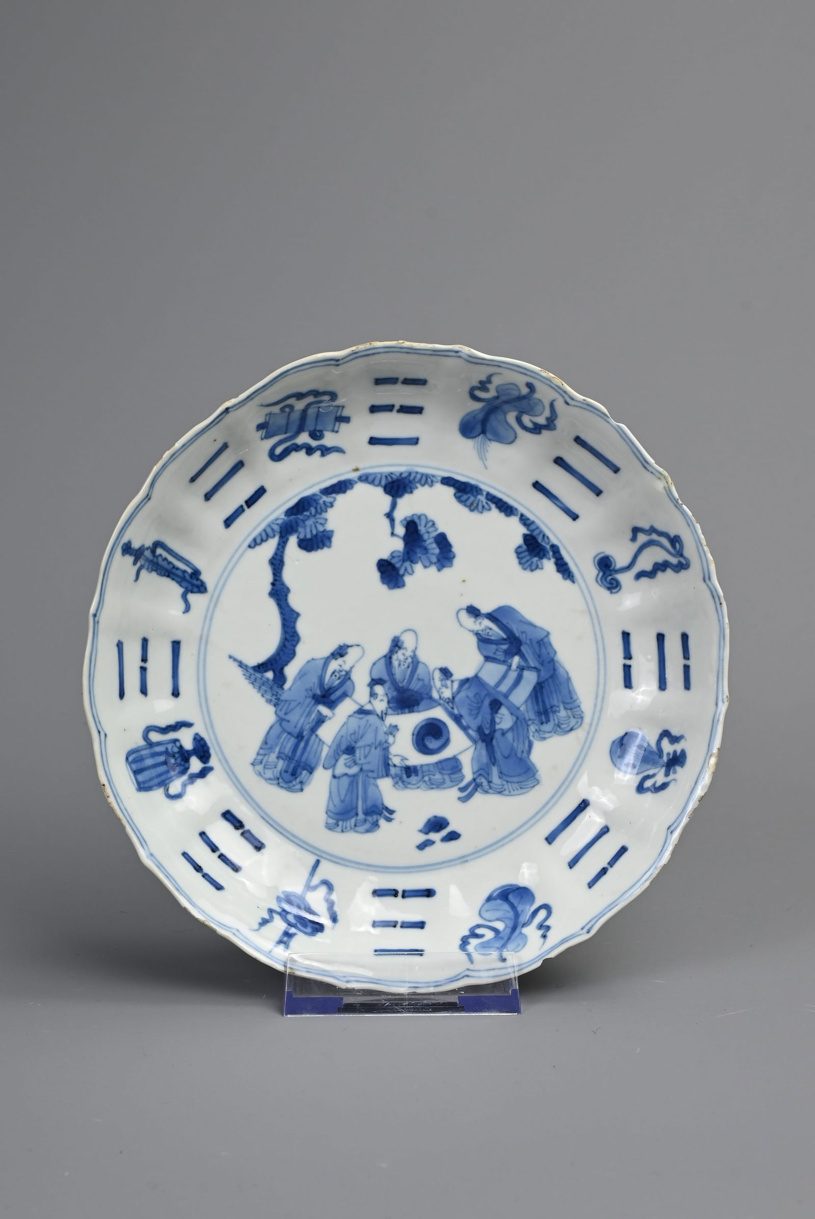 A CHINESE BLUE AND WHITE PORCELAIN DISH, EARLY 18TH CENTURY. Of lobed form decorated with scholars (1 of 6)