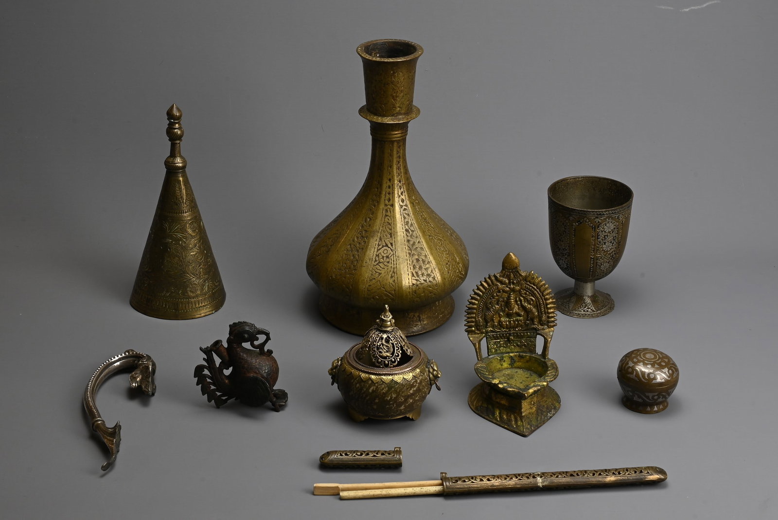A GROUP OF MIXED METAL ITEMS, INDIAN AND SOUTH EAST ASIAN. Comprising a bronze hookah base; An oil (1 of 5)