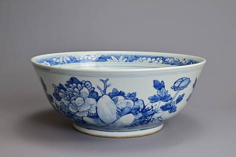 A LARGE CHINESE BLUE AND WHITE PORCELAIN BOWL, 19TH CENTURY. Well potted rounded sides decorated: A LARGE CHINESE BLUE AND WHITE PORCELAIN BOWL, 19TH CENTURY. Well potted rounded sides decorated with a bird and large peony blooms. The interior with a peony spray and floral band at the rim. 37cm di