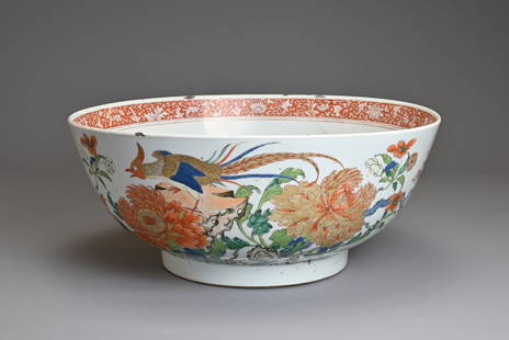 A LARGE CHINESE FAMILLE VERTE PORCELAIN BOWL, 18TH CENTURY. Decorated with pheasants on a rockwork: A LARGE CHINESE FAMILLE VERTE PORCELAIN BOWL, 18TH CENTURY. Decorated with pheasants on a rockwork base with flowering peony blossoms. Further decorated to the interior with peony medallion and floral