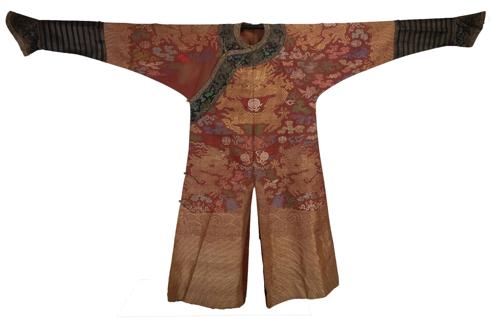 A CHINESE BROCADED SILK RED-GROUND DRAGON ROBE, LATE QING DYNASTY. Finely embroidered with gold (1 of 7)