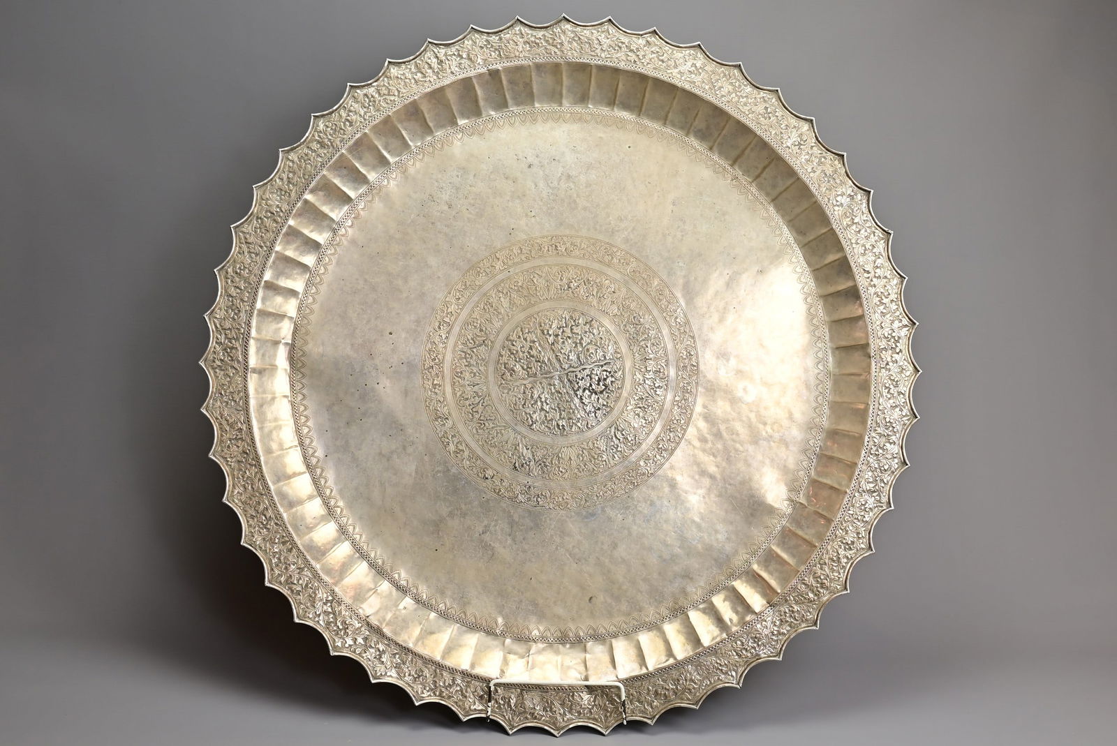 A LARGE MALAY ARCHIPELAGO SILVER ALLOY TRAY WITH STAR SHAPED RIM, EARLY 20TH CENTURY (1 of 6)