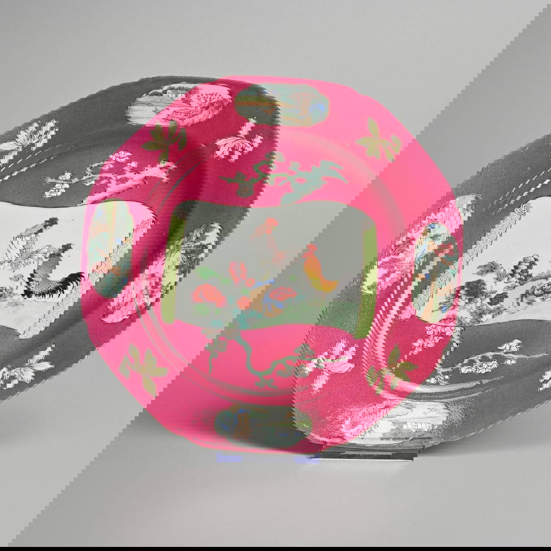 A CHINESE RUBY GROUND FAMILLE ROSE PORCELAIN ROOSTER DISH, 18TH CENTURY.