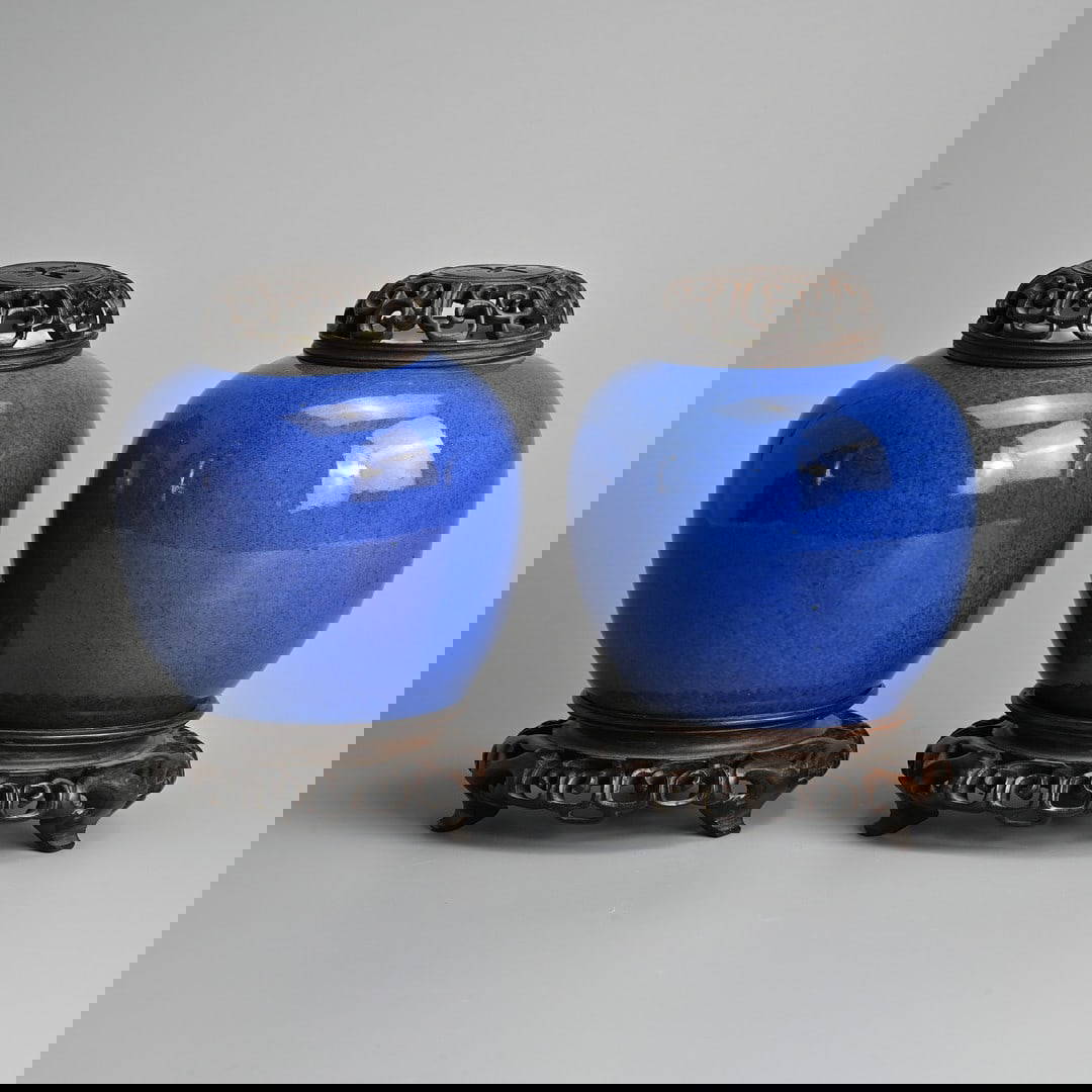 A PAIR OF CHINESE POWDER BLUE PORCELAIN JARS WITH WOODEN STANDS AND COVERS, 19TH CENTURY.
