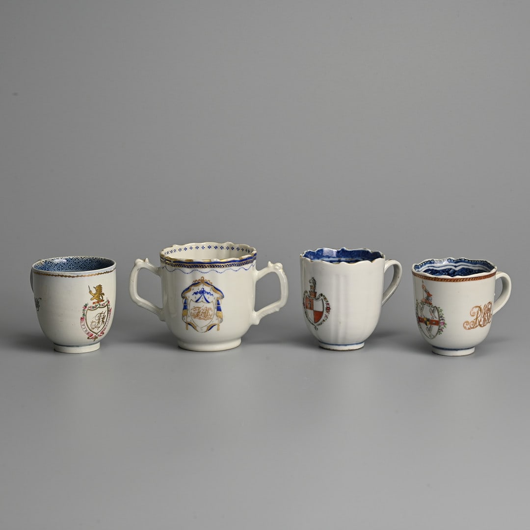 TWO CHINESE EXPORT ARMORIAL PORCELAIN COFFEE-CUPS AND A TWO-HANDLED CHOCOLATE CUP, QIANLONG