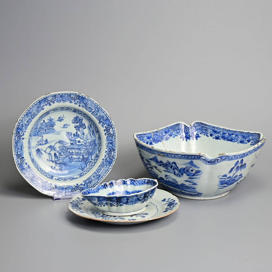 A GROUP OF CHINESE BLUE AND WHITE PORCELAIN ITEMS, 18TH CENTURY.: To include a square form bowl with lobed sides decorated with buildings in a coastal scene, the base written W. Daltrey Wiggington; A lobed sauce boat similarly decorated; Together with two dishes wit