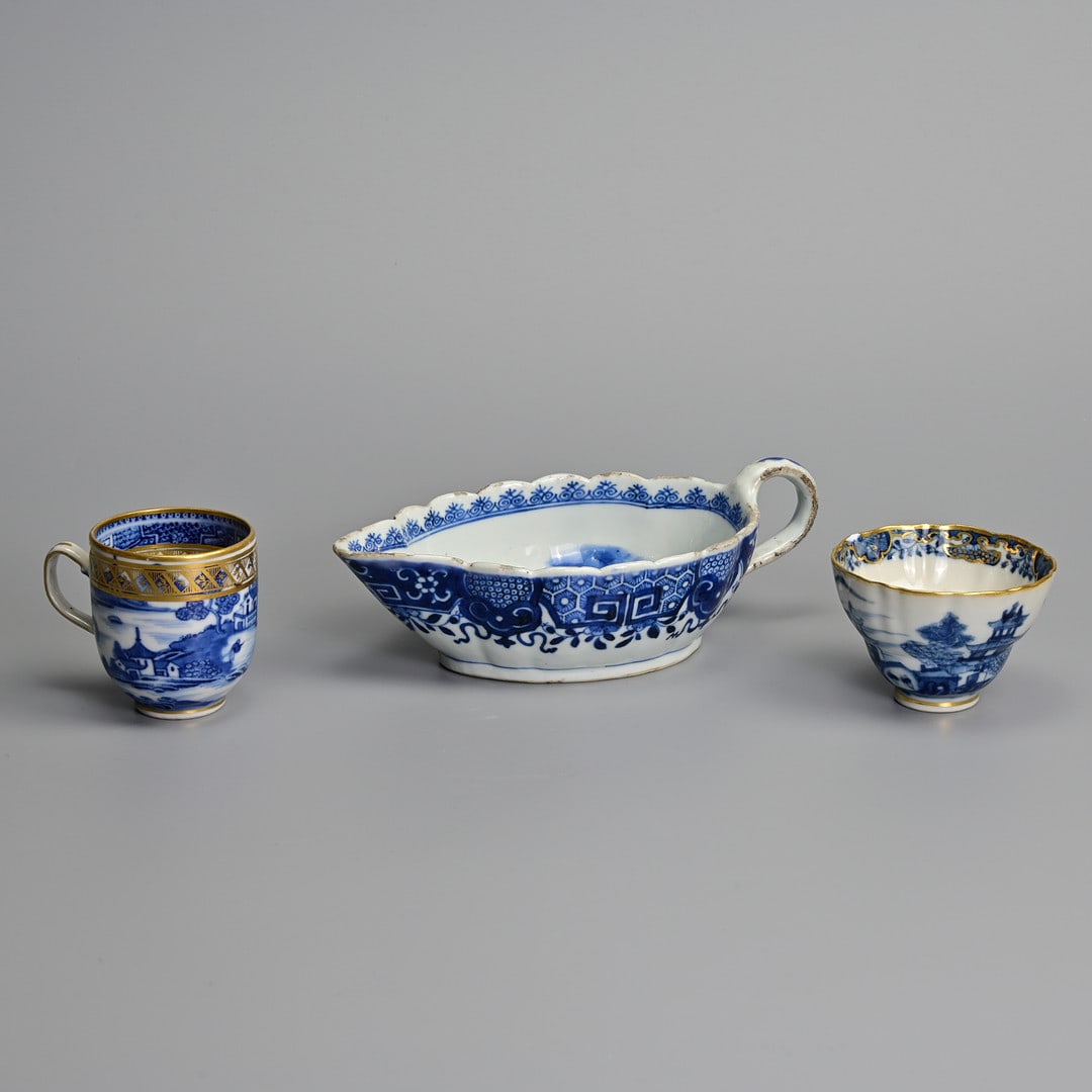 A CHINESE BLUE AND WHITE PORCELAIN FLUTED SAUCEBOAT, A TEABOWL AND A COFFEE-CUP, LATE 18TH/EARLY