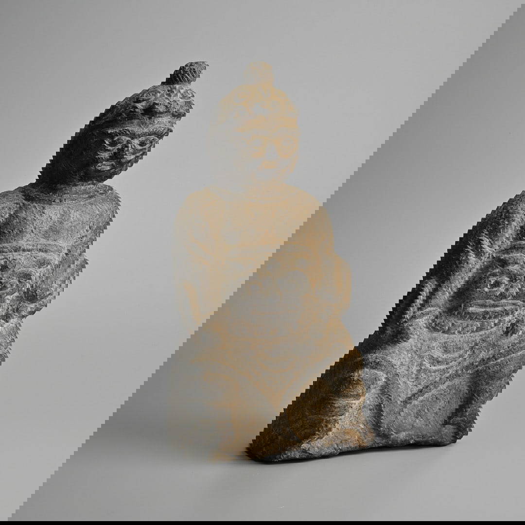 A CHINESE CARVED STONE FIGURE OF A SEATED GENERAL, LATE MING DYNASTY.