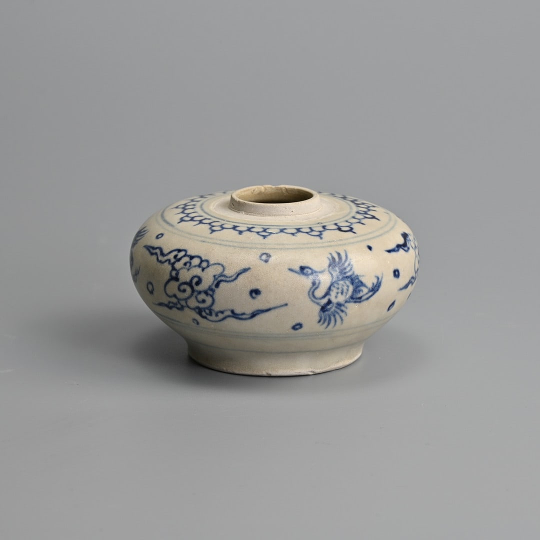 A FINE VIETNAMESE BLUE AND WHITE POTTERY JARLET, 15TH CENTURY.: Of squat from finely painted with alternating birds and flaming clouds, below a decorated band around the shoulder. 9cm diam x 4.5cm tall.