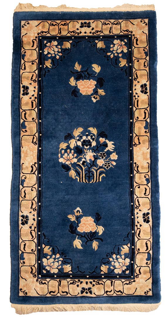 A CHINESE PEKING BLUE-GROUND WOOL RUG, 20TH CENTURY.