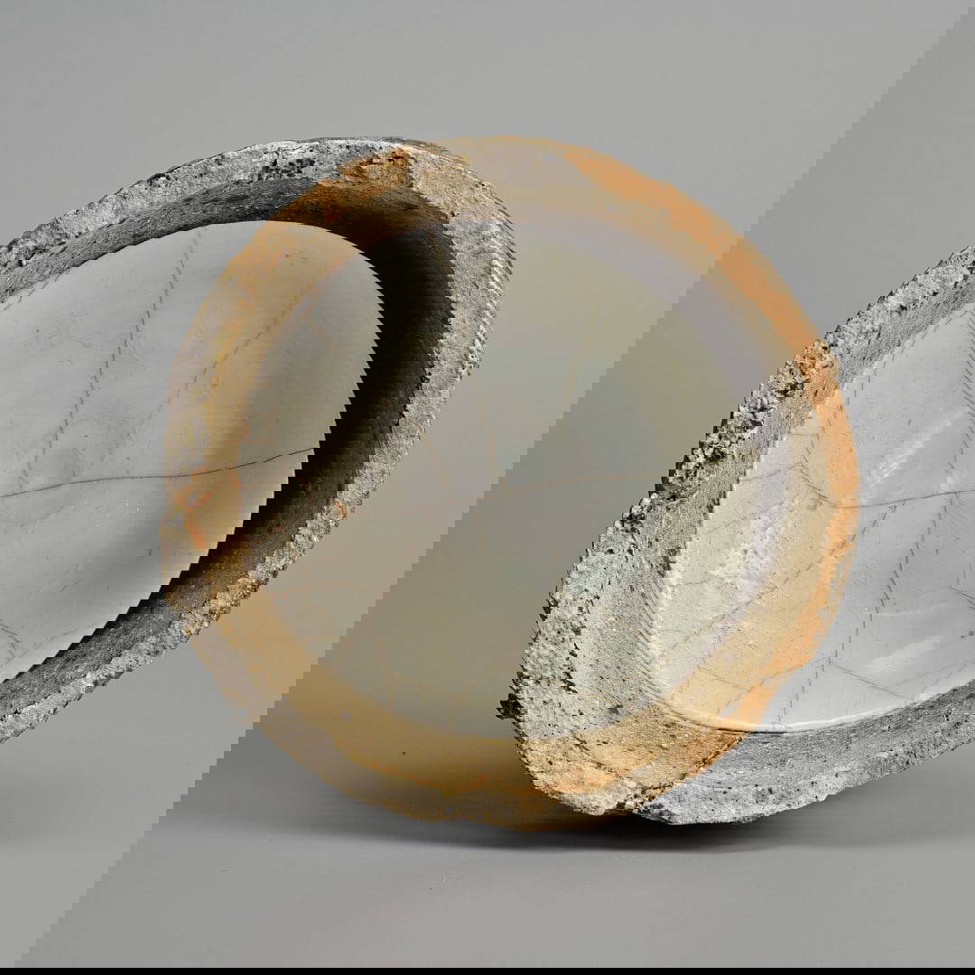 A CHINESE NORTHERN SONG DYNASTY QINGBAI PORCELAIN DISH IN KILN SAGGAR (AD 960 – 1127).