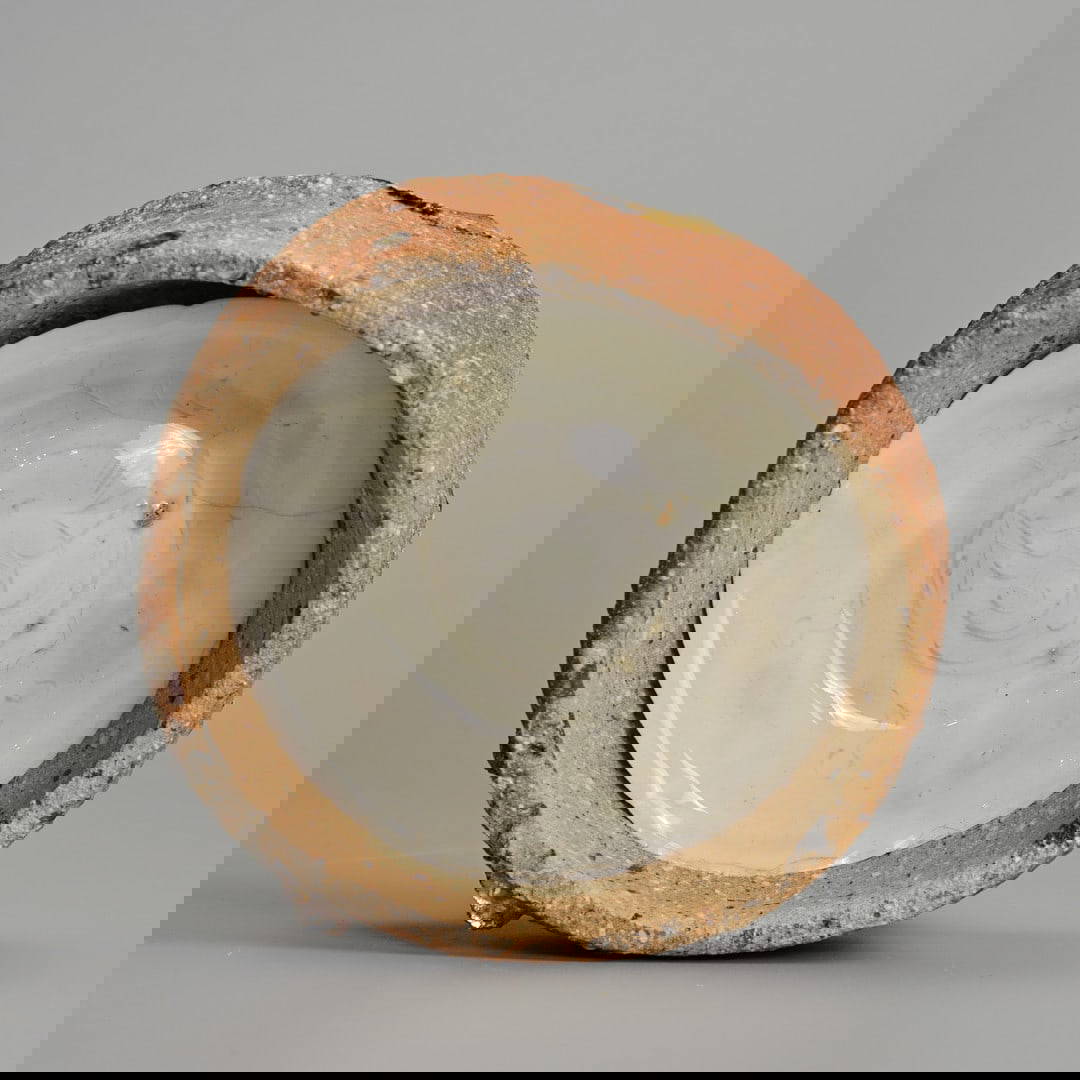 A CHINESE NORTHERN SONG DYNASTY QINGBAI PORCELAIN DISH IN KILN SAGGAR (AD 960 – 1127).