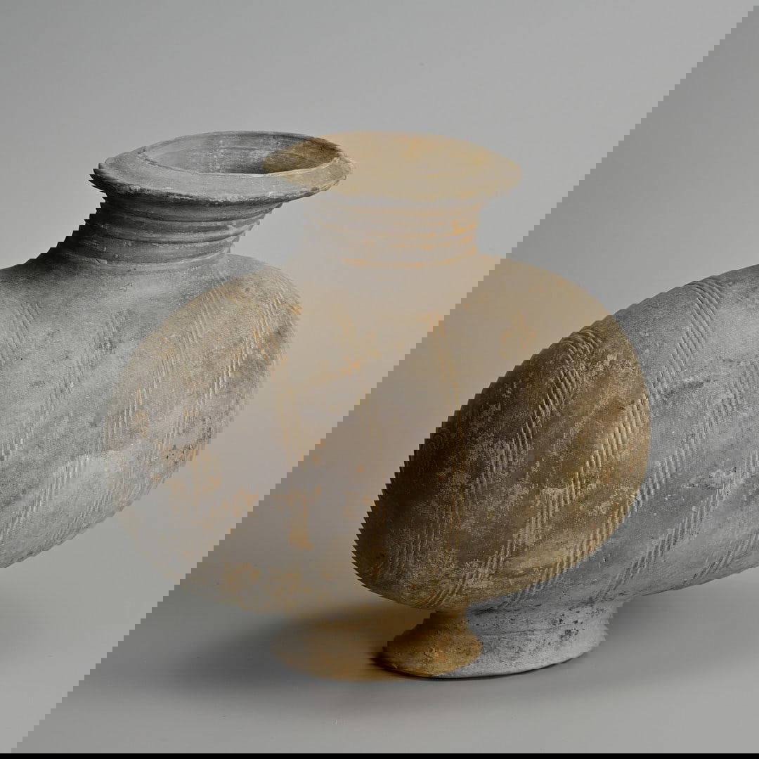 A CHINESE BURNISHED POTTERY COCOON JAR, WESTERN HAN DYNASTY (206 BC – AD 8).