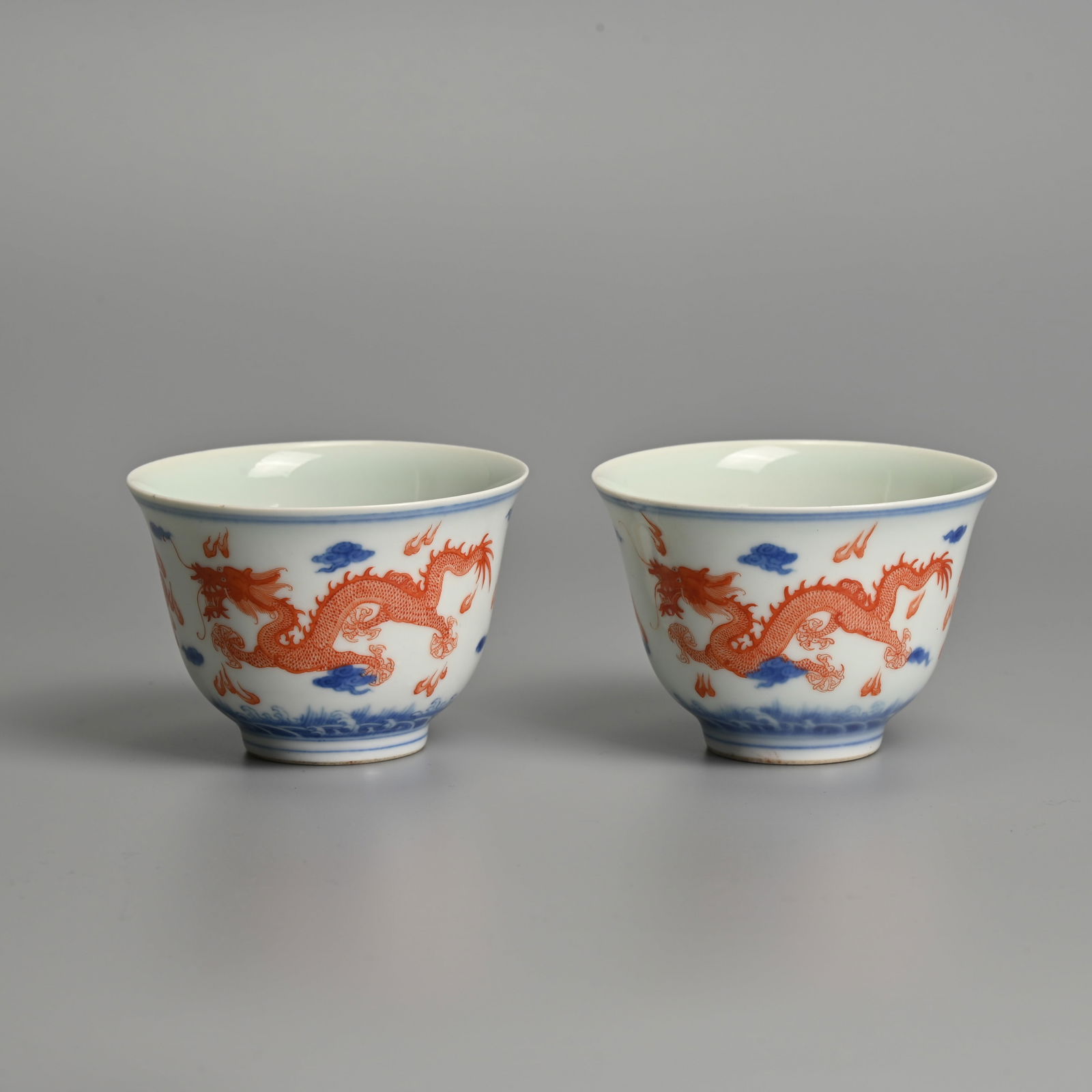 A PAIR OF CHINESE IRON-RED AND UNDERGLAZE BLUE PORCELAIN 'DRAGON' CUPS, JIAQING MARKS. (1 of 8)
