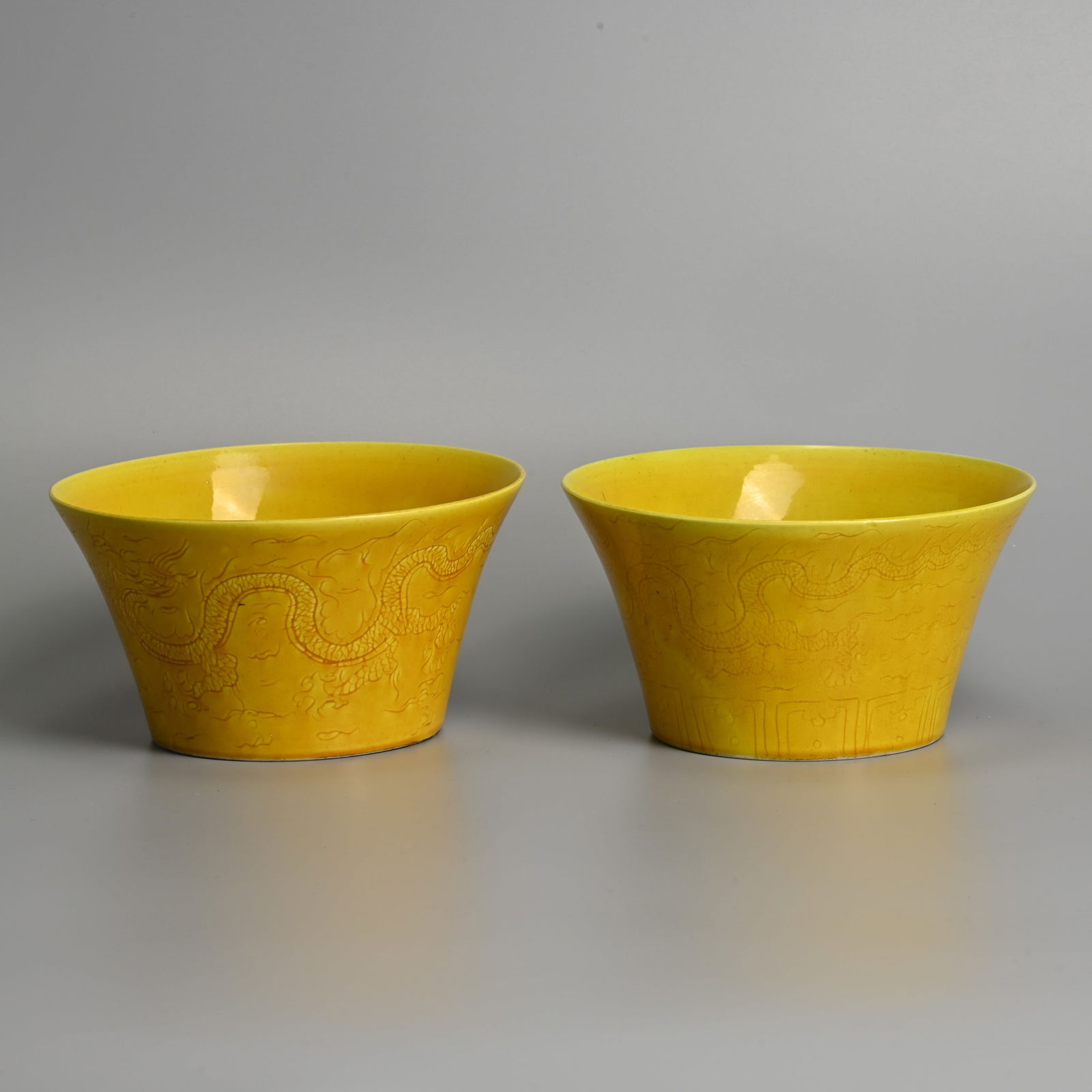 A PAIR OF CHINESE YELLOW GLAZED PORCELAIN 'DRAGON AND PHOENIX' BOWLS, 20TH CENTURY. (1 of 7)