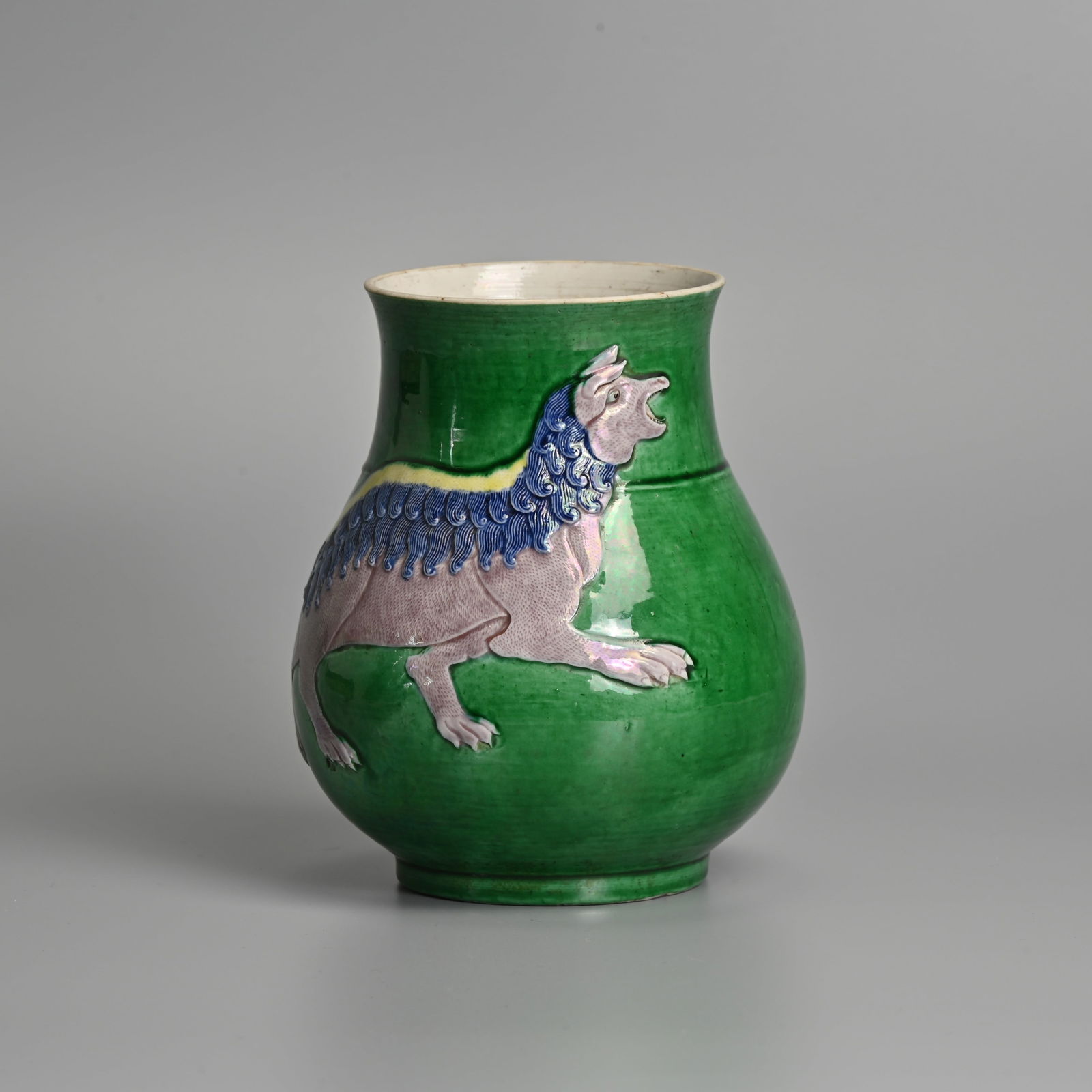A CHINESE GREEN, AUBERGINE AND YELLOW GLAZED PORCELAIN 'MYTHICAL BEAST' HU FORM VASE, IMPRESSED QIAN: A CHINESE GREEN, AUBERGINE AND YELLOW GLAZED PORCELAIN 'MYTHICAL BEAST' HU FORM VASE, IMPRESSED QIANLONG MARK, QING DYNASTY. Wide pear shaped body featuring a finely carved mythical beast in low relie