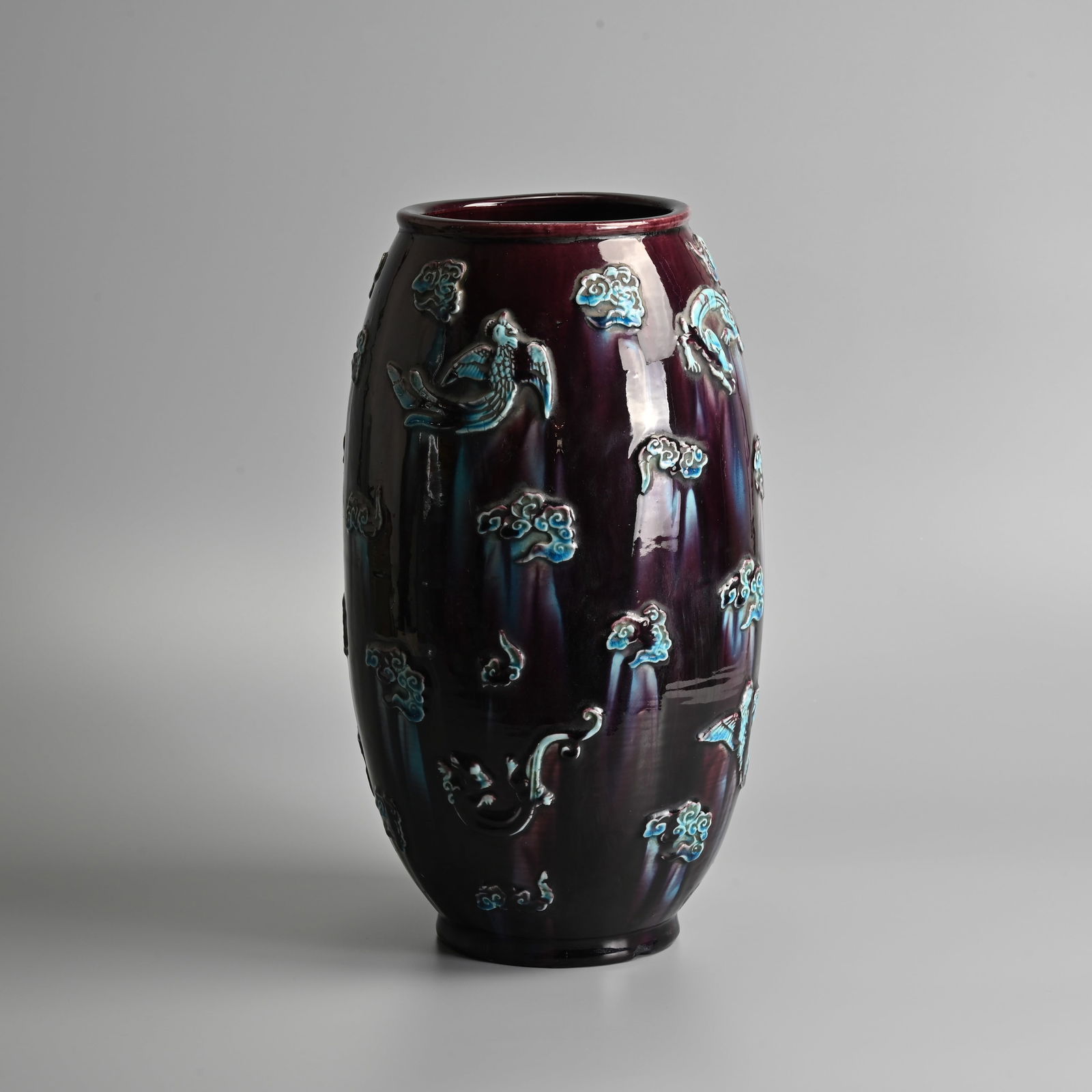 A CHINESE TURQUOISE AND AUBERGINE GLAZED APPLIQUE-DECORATED PORCELAIN VASE, QING DYNASTY.: A CHINESE TURQUOISE AND AUBERGINE GLAZED APPLIQUE-DECORATED PORCELAIN VASE, QING DYNASTY. Of ovoid form decorated with various phoenix and chilong amidst cloud scrolls applied to the body. 36cm tall.