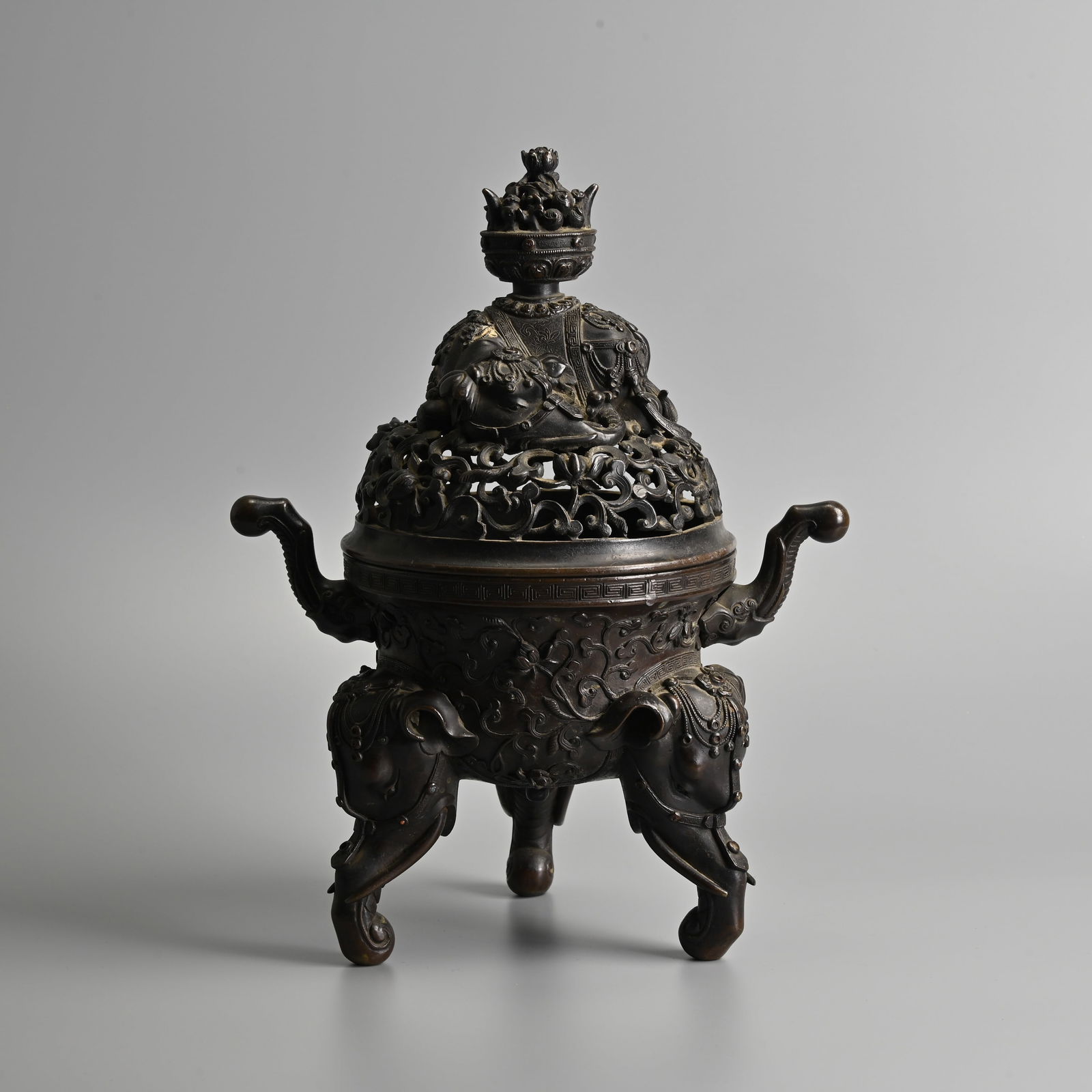 AN ORNATE CHINESE BRONZE 'ELEPHANT' TRIPOD CENSER, QING DYNASTY. (1 of 11)