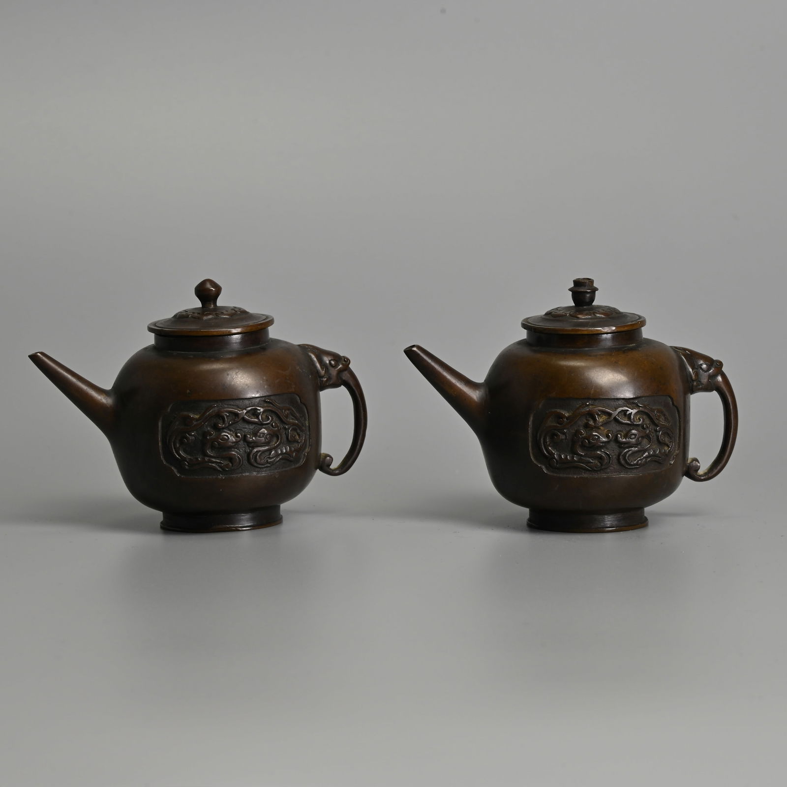 A PAIR OF CHINESE SMALL BRONZE EWERS WITH COVERS, QING DYNASTY. (1 of 11)