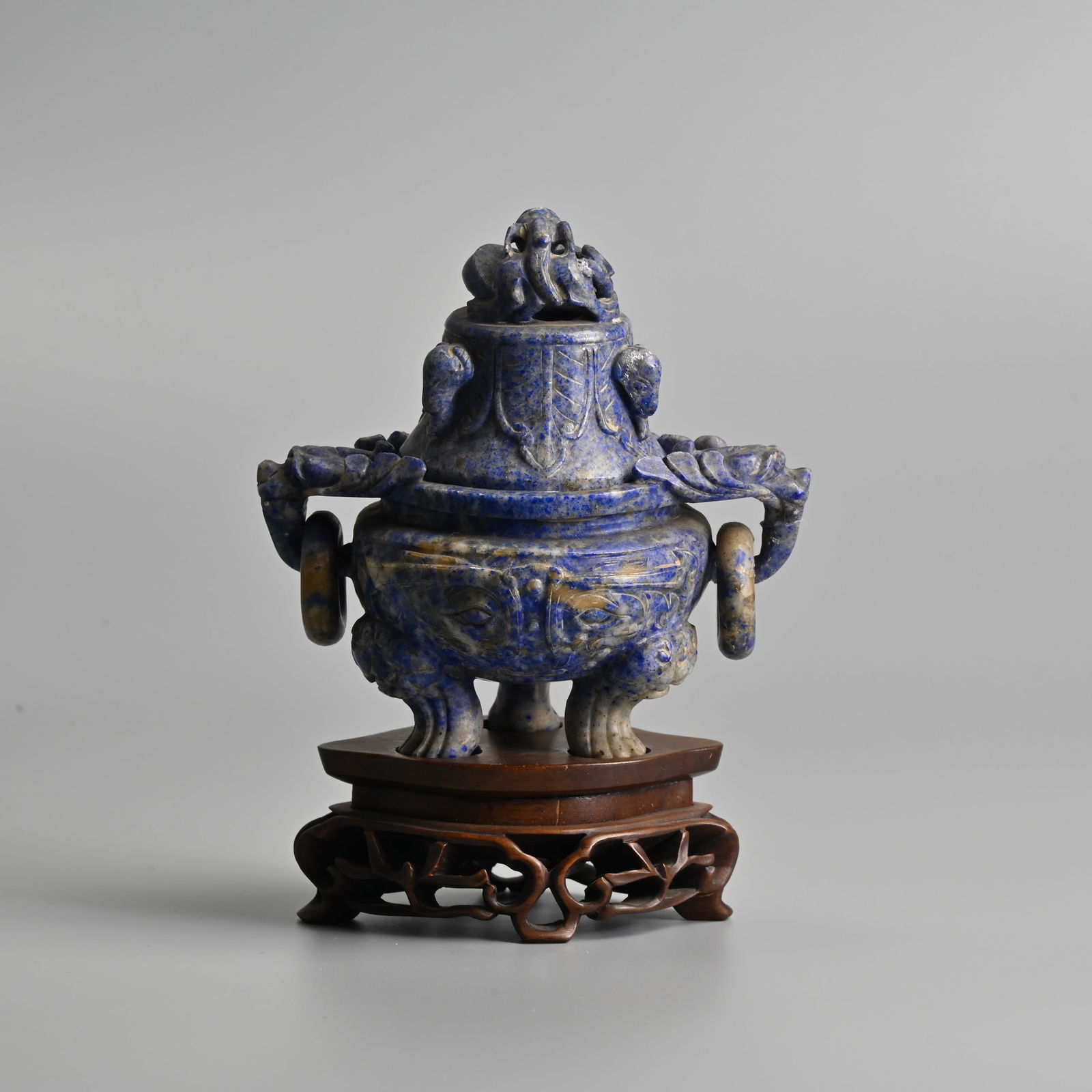 A BOXED CHINESE CARVED LAPIS LAZULI CENSER AND COVER WITH WOODEN STAND, EARLY 20TH CENTURY.: A BOXED CHINESE CARVED LAPIS LAZULI CENSER AND COVER WITH WOODEN STAND, EARLY 20TH CENTURY. With pierced dragon and elephant carved domed cover, the censer with beast ring handles, raised on paw feet,