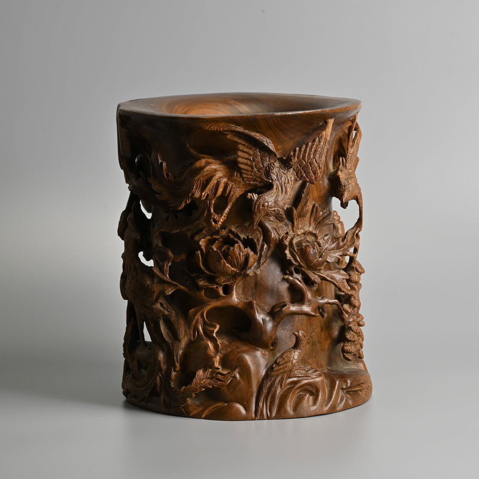 A LARGE AND HEAVY CHINESE HARDWOOD 'PHOENIX' BRUSH POT, 20TH CENTURY.: A LARGE AND HEAVY CHINESE HARDWOOD 'PHOENIX' BRUSH POT, 20TH CENTURY. Well carved in deep relief and open work featuring phoenix in flight and on rockwork, with large peony blooms on branches. 24.8cm