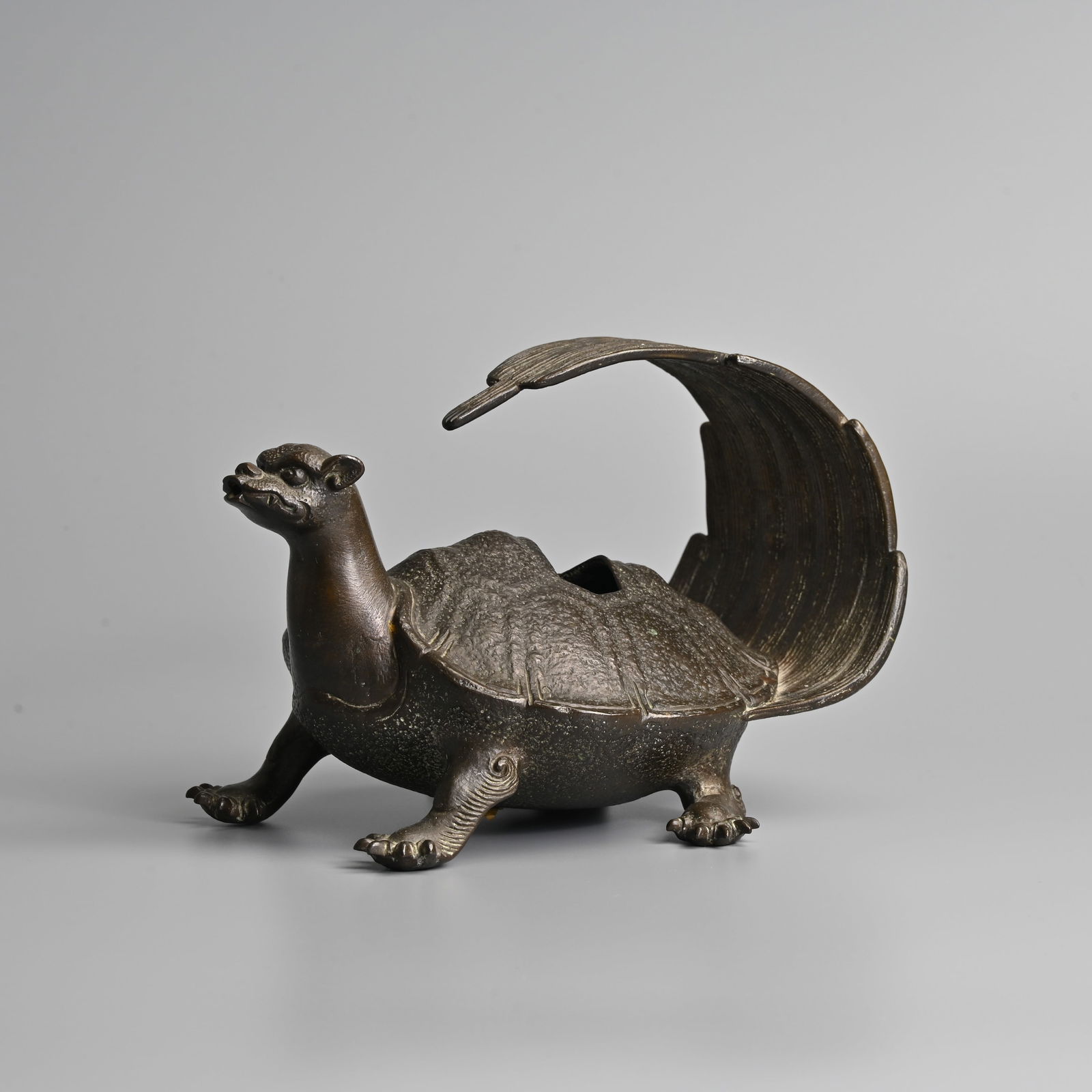 A JAPANESE BRONZE MINOGAME CENSER, 19TH CENTURY, MEIJI PERIOD.: A JAPANESE BRONZE MINOGAME CENSER, 19TH CENTURY, MEIJI PERIOD. Modelled standing with its fan-shaped tail overturned, with hexagonal shaped aperture to shell and small aperture to mouth, 7 cm long. Co