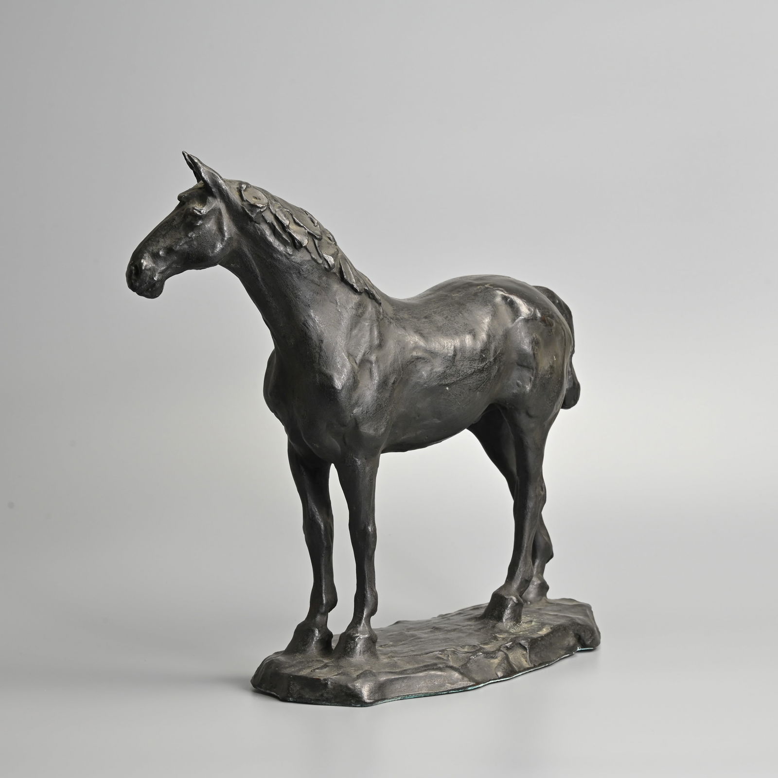 A LARGE JAPANESE BRONZE MODEL OF A HORSE, EARLY 20TH CENTURY, SIGNED BY THE TOKYO ARSENAL.: A LARGE JAPANESE BRONZE MODEL OF A HORSE, EARLY 20TH CENTURY, SIGNED BY THE TOKYO ARSENAL. The stallion standing four square, with its head turned slightly to the right, on a grassy mound base, inscri