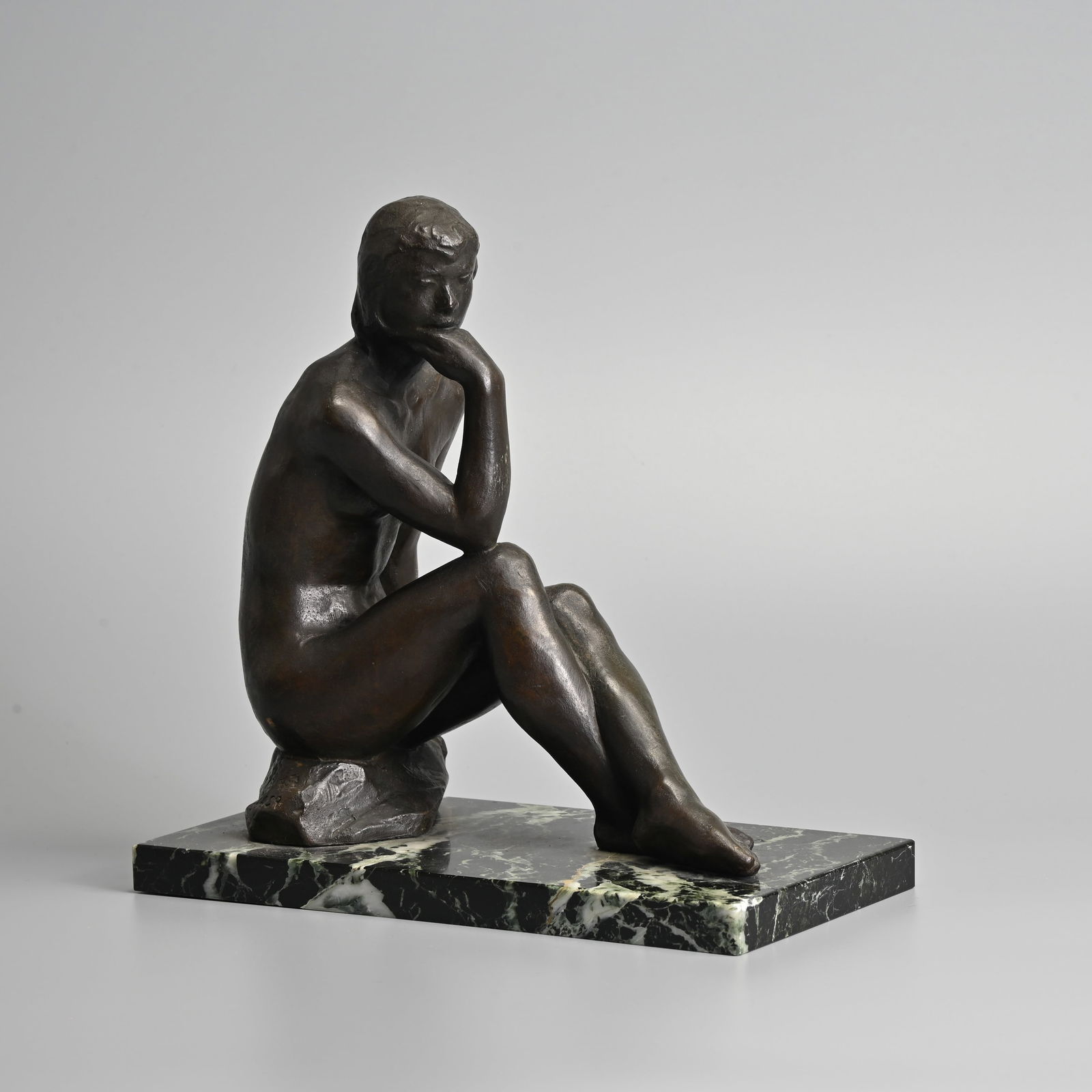 A JAPANESE BRONZE FIGURE OF A FEMALE NUDE, 'FIRST LOVE' AFTER MASAHIKO YAMAMOTO (1893-1985), ON MARB: A JAPANESE BRONZE FIGURE OF A FEMALE NUDE, 'FIRST LOVE' AFTER MASAHIKO YAMAMOTO (1893-1985), ON MARBLE BASE, LATE 20TH CENTURY. She seated on rockwork, with her hand resting on her chin, on veined bla