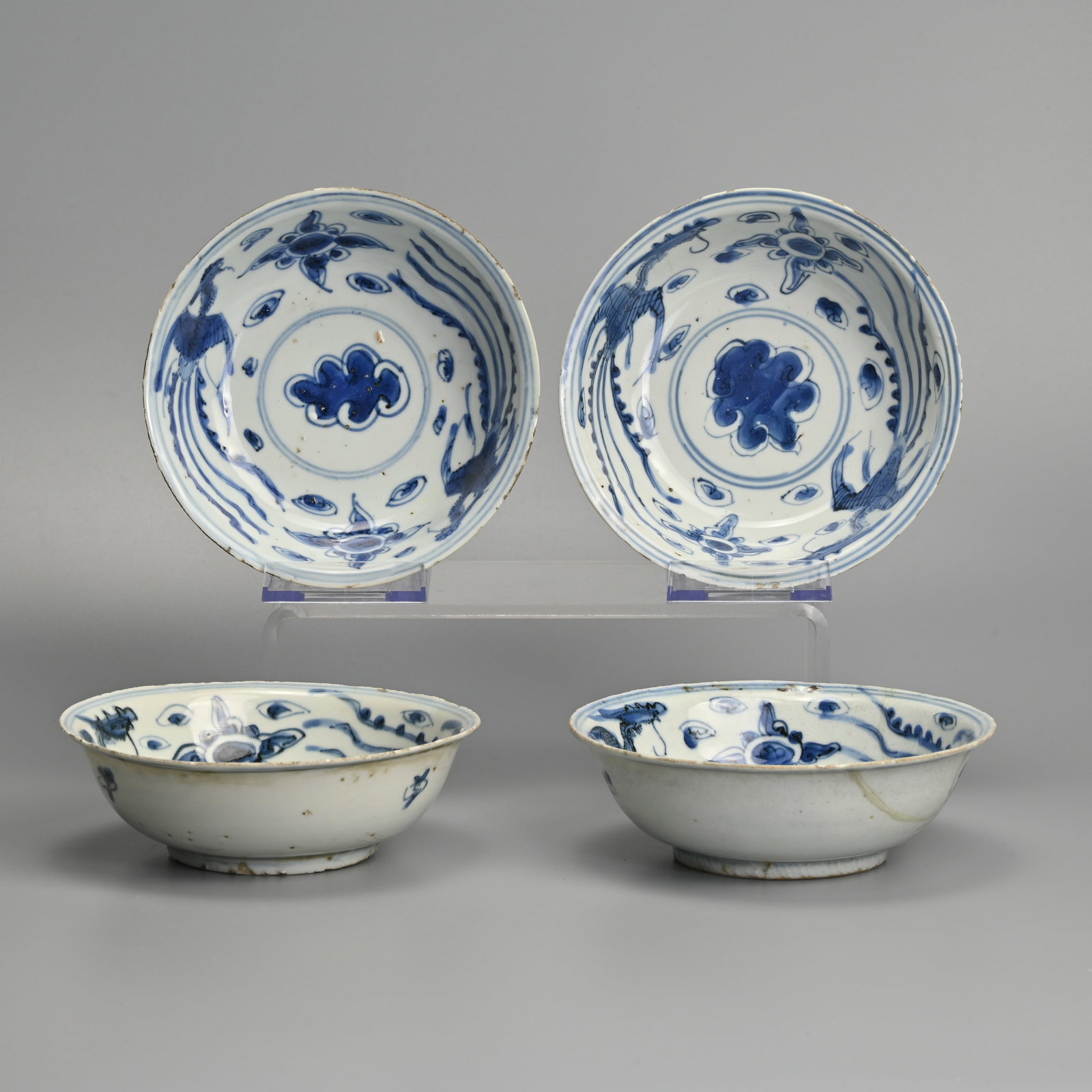 FOUR CHINESE KO-SOMETSUKE PORCELAIN BLUE AND WHITE PHOENIX DISHES, LATE MING DYNASTY, TIANQI PERIOD: The interior of each painted with two phoenix and two lotus flowers centred by a leaf, within double concentric lines, the exterior with leaves, 14.3 cm diam. (4) Provenance: Private collection, Japan