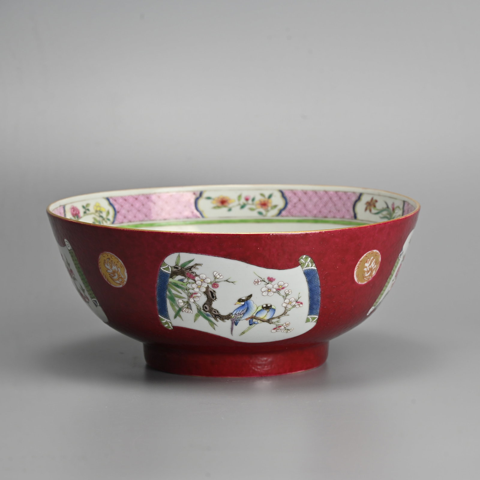 A LARGE CHINESE FAMILLE ROSE RUBY GROUND PORCELAIN BOWL. (1 of 7)