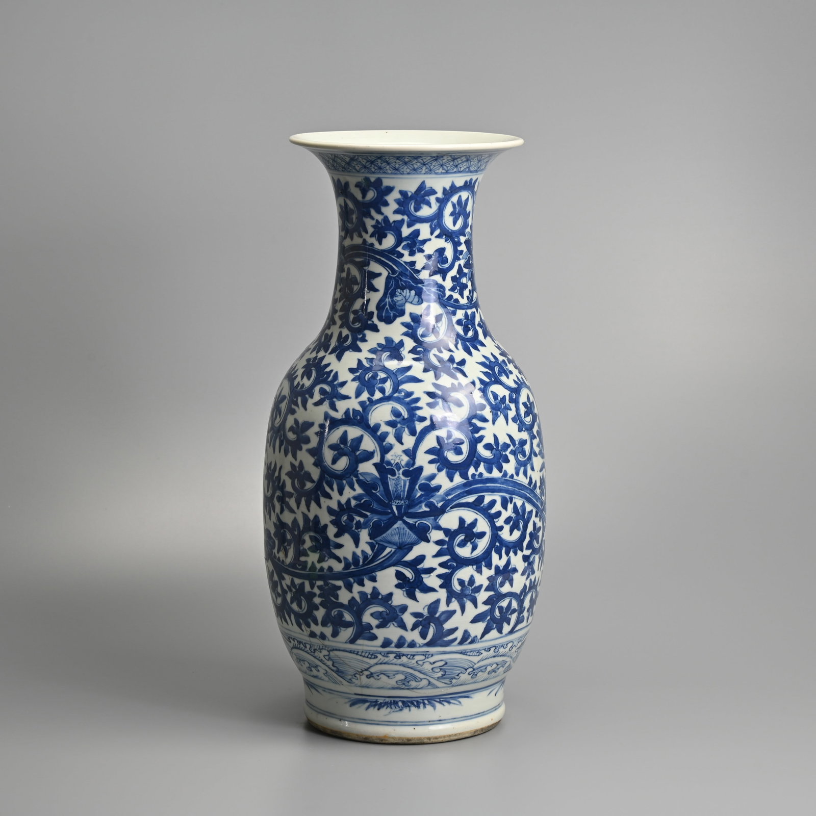A LARGE CHINESE BLUE AND WHITE PORCELAIN 'LOTUS SCROLL' VASE, 19TH CENTURY.: Of baluster form decorated with a continuous pattern of lotus scrolls. 44.5cm tall.